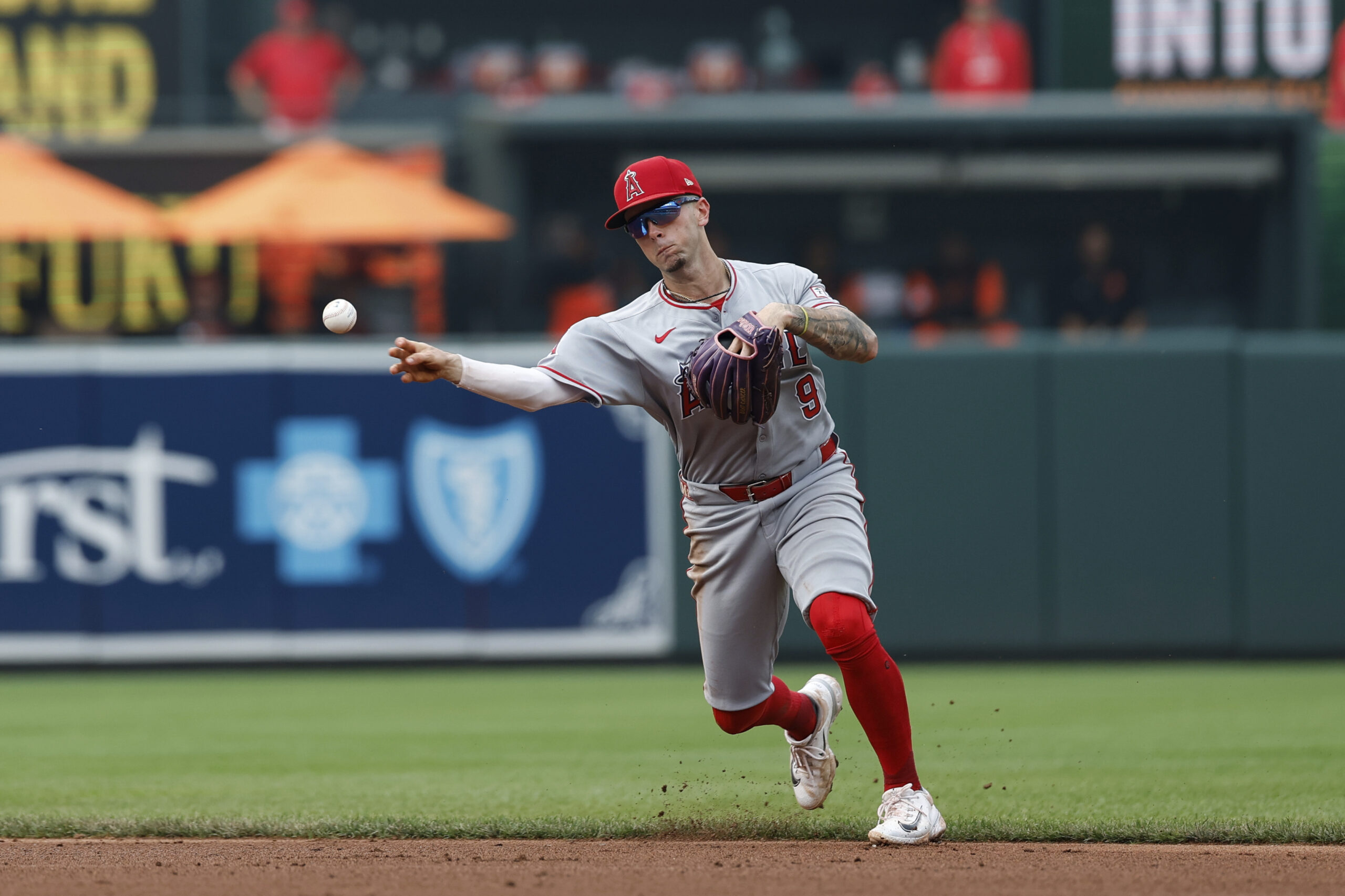 Angels shortstop Zach Neto (9) throws to first base for...