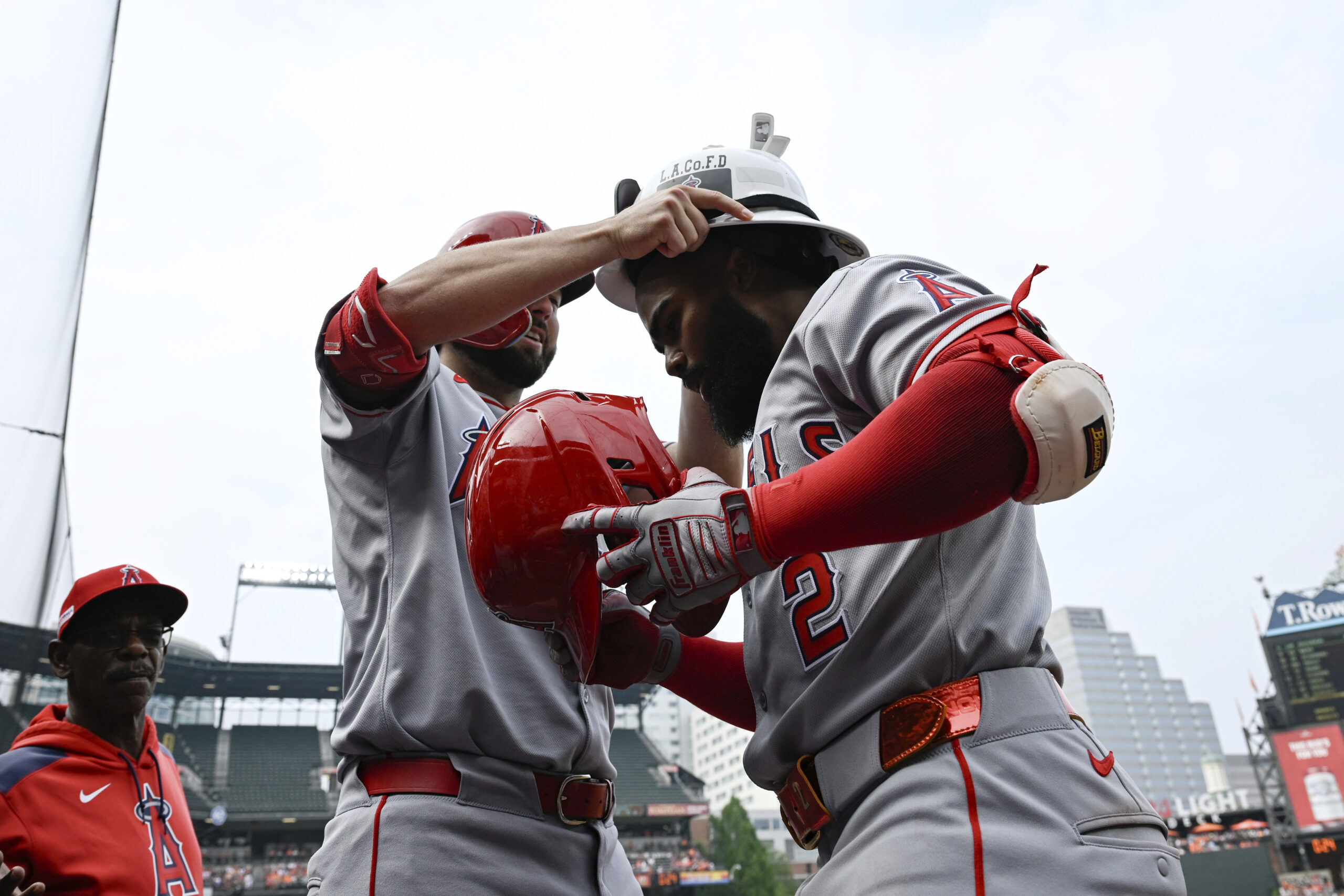 Angels’ Luis Rengifo (2) has a firefighters helmet placed on...