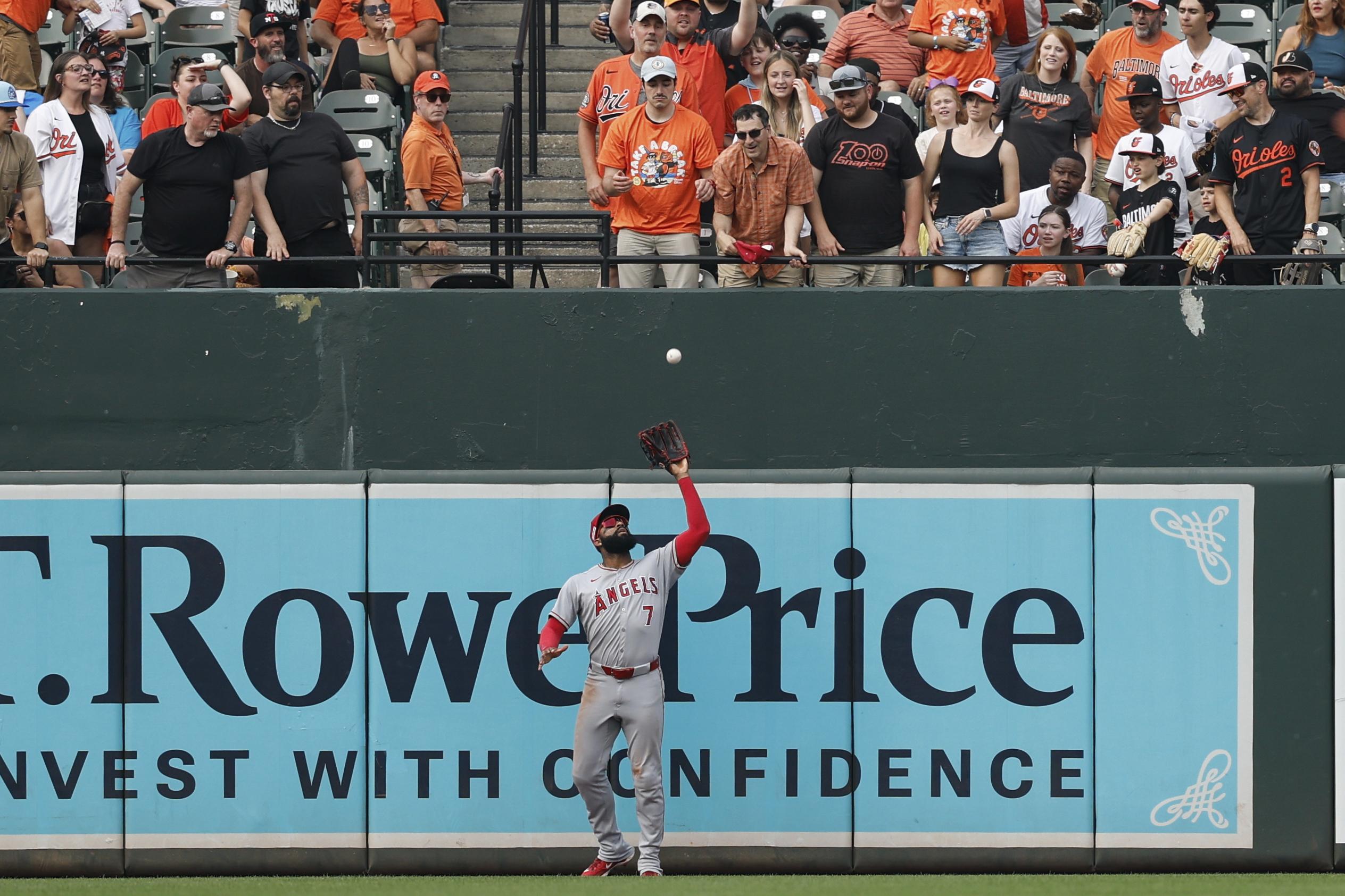 Angels outfielder Jo Adell (7) catches a fly ball hit...