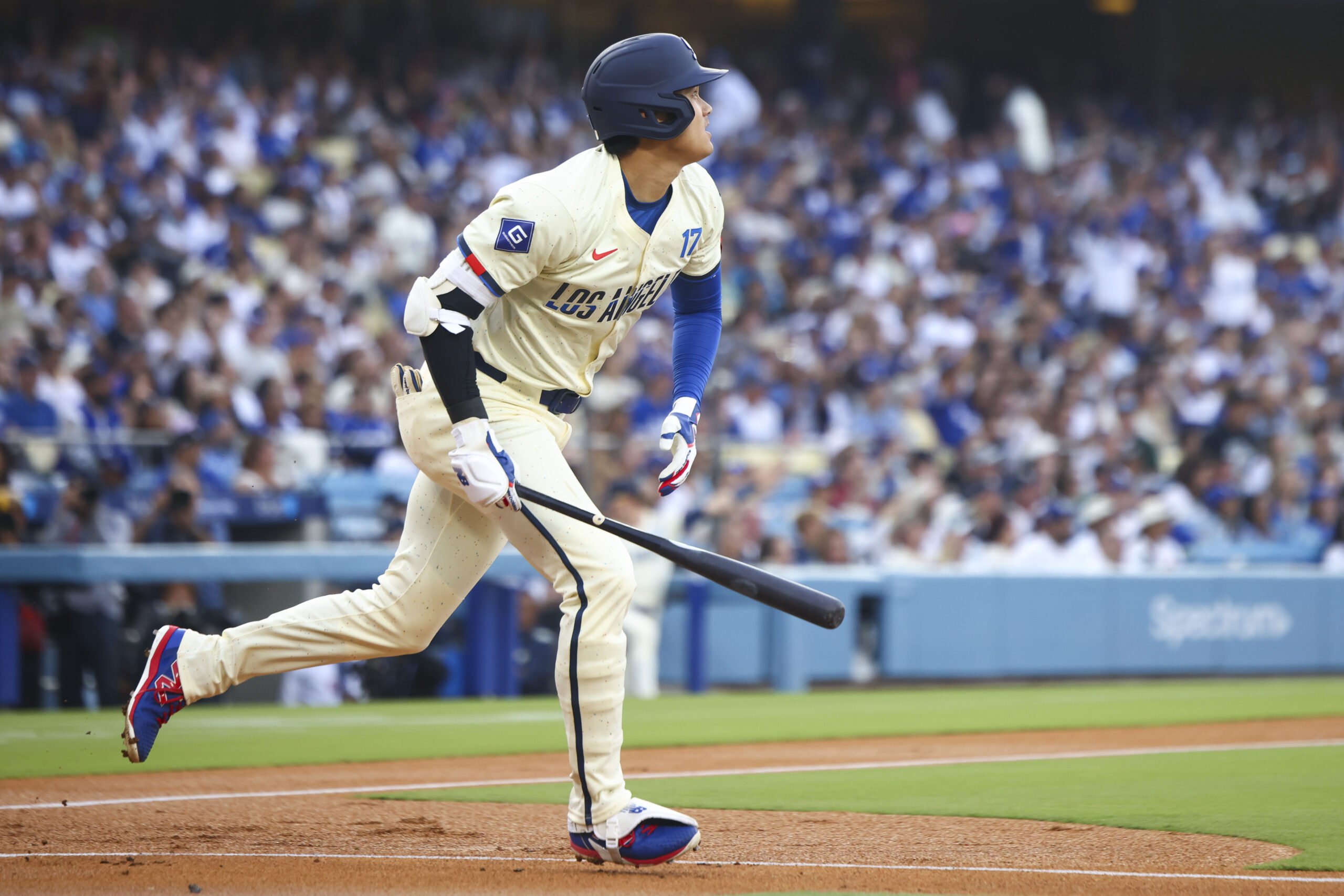 Dodgers designated hitter Shohei Ohtani runs after hitting a home...