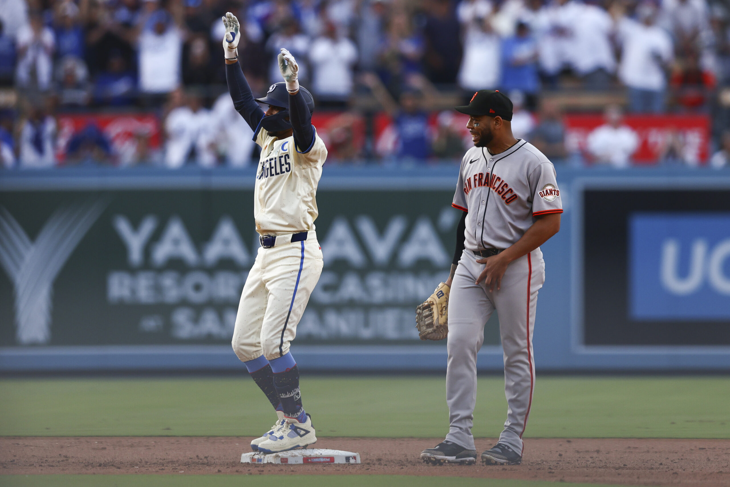 Dodgers’ Mookie Betts gestures after hitting an RBI double as...