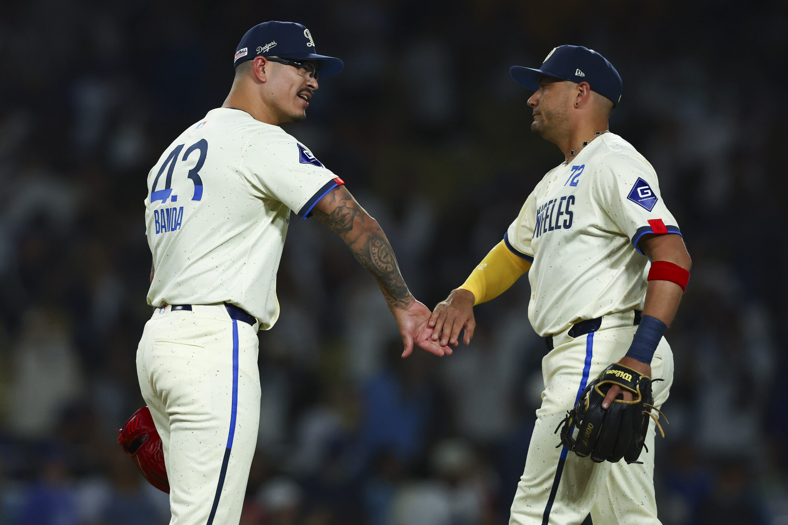 Dodgers pitcher Anthony Banda (43) and second baseman Miguel Rojas,...