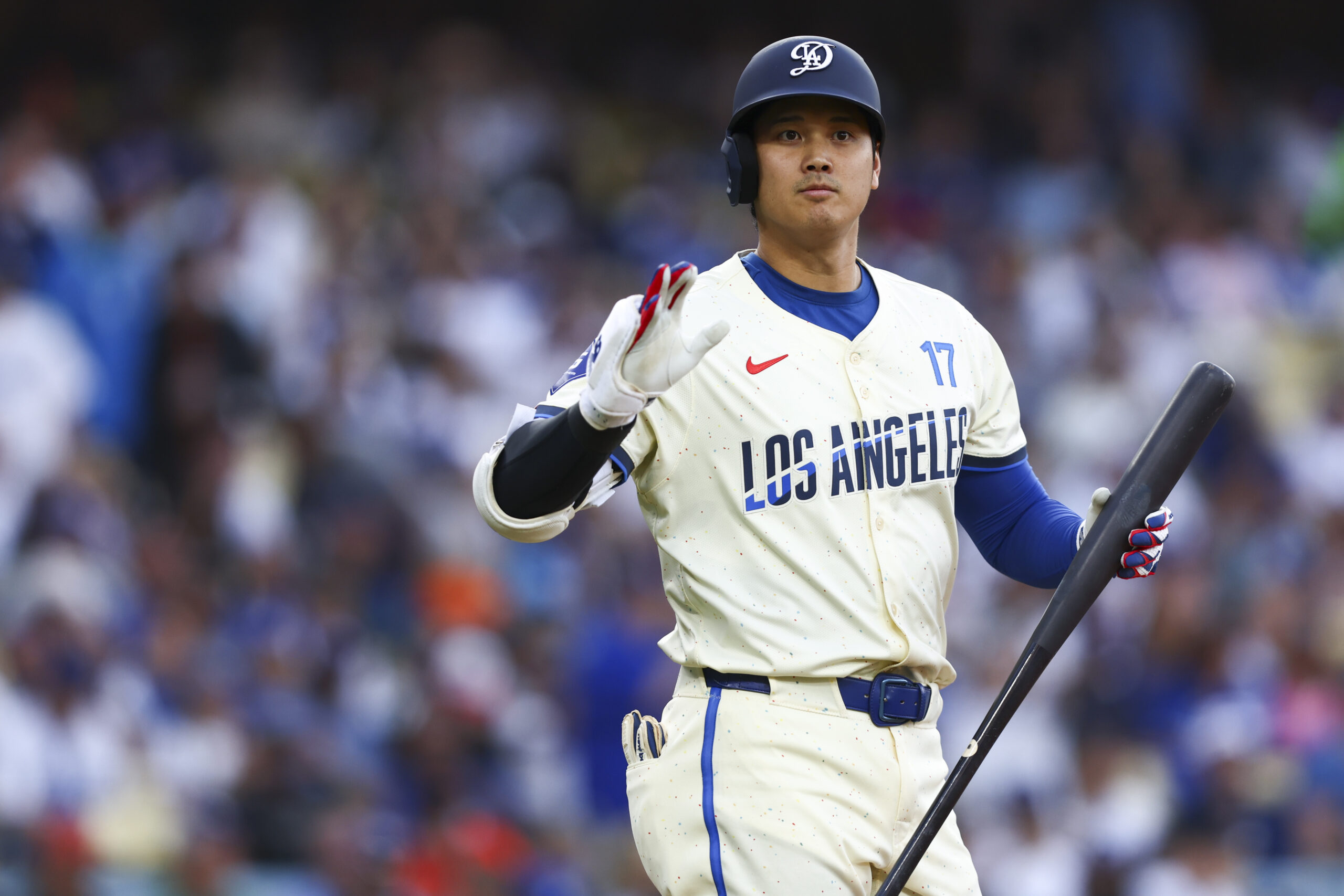 Dodgers designated hitter Shohei Ohtani gestures during the first inning...