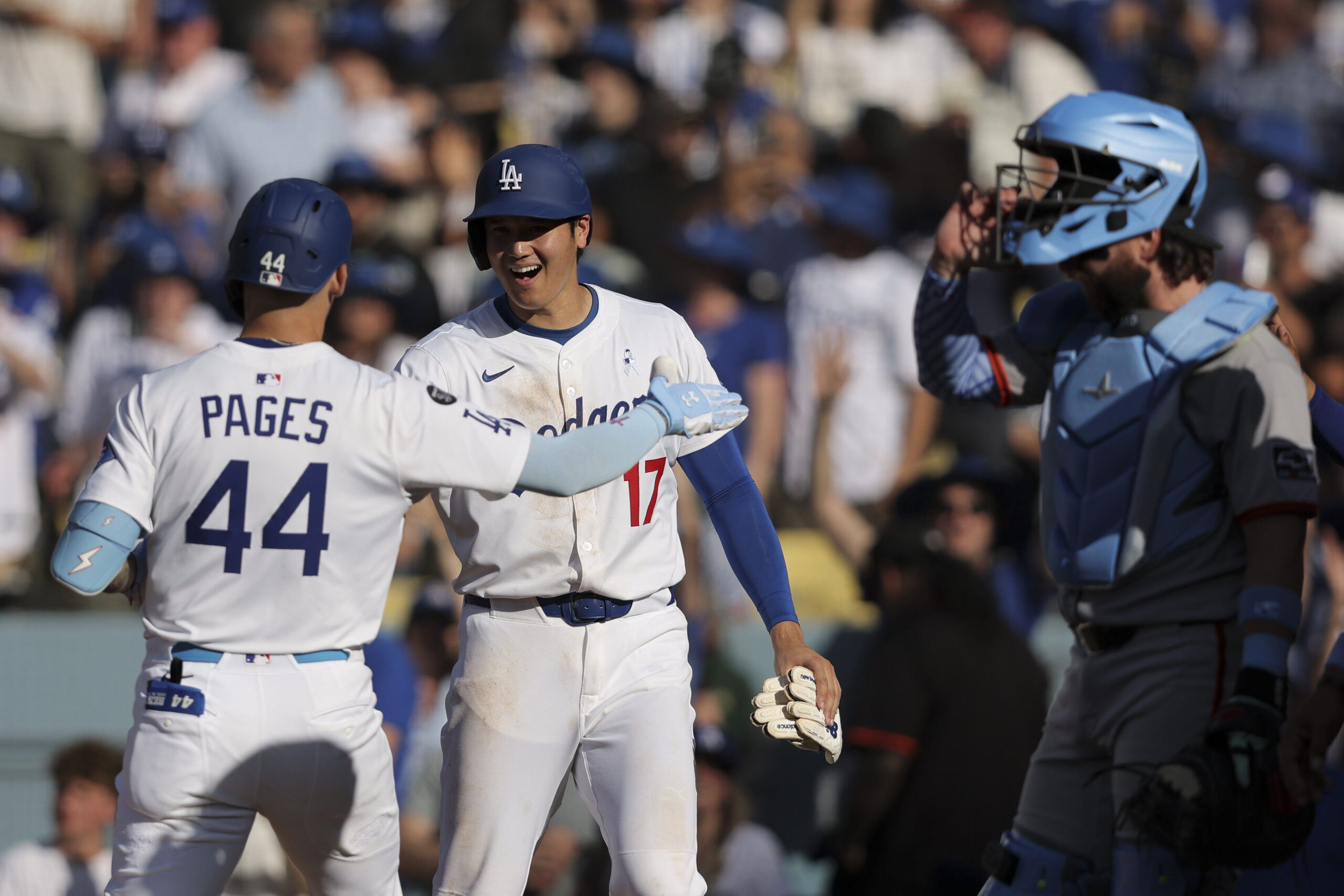 Dodgers’ Andy Pages (44) celebrates with designated hitter Shohei Ohtani...