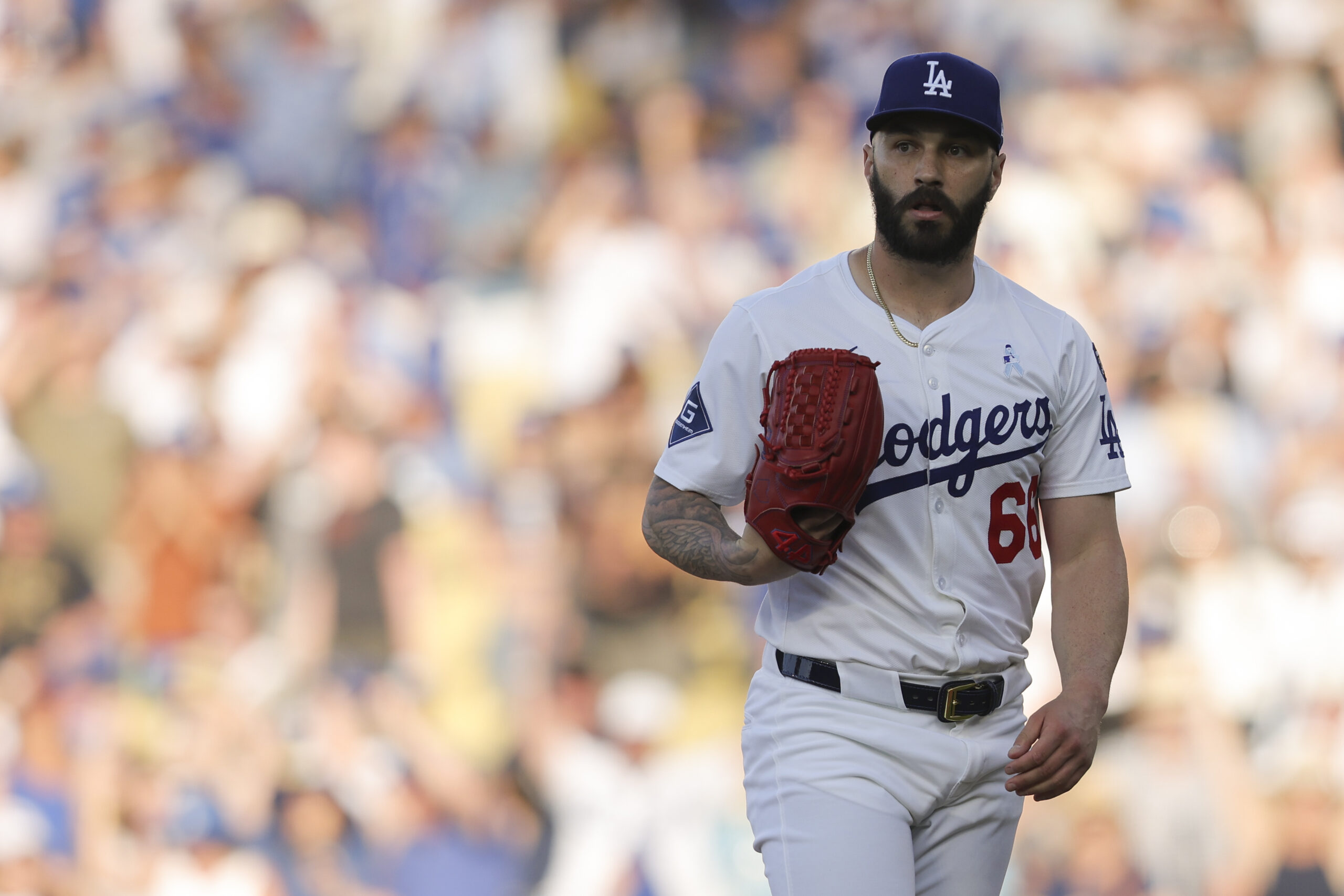 Dodgers pitcher Tanner Scott looks on after striking out the...