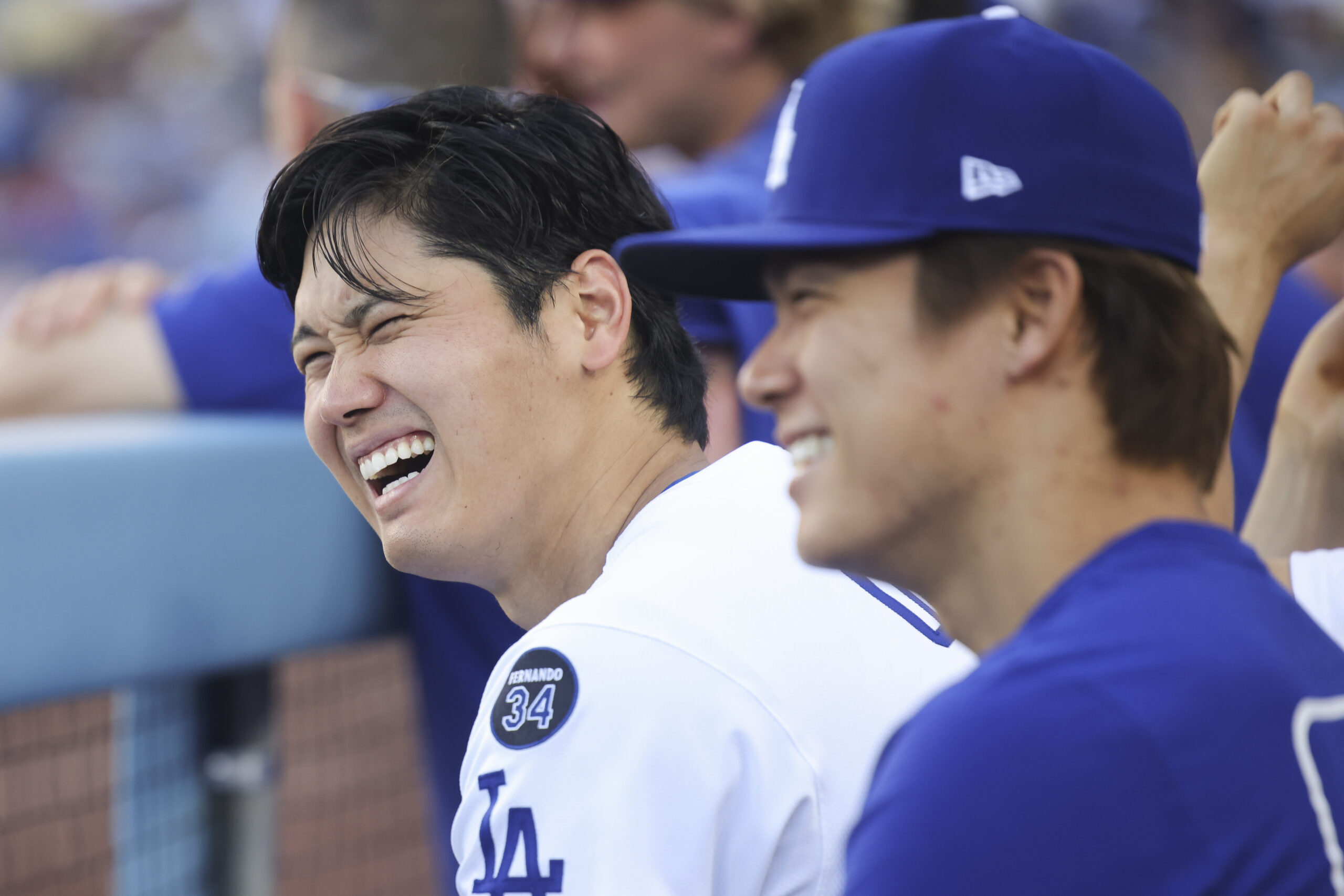 Dodgers’ Shohei Ohtani reacts alongside Yoshinobu Yamamoto during the eighth...