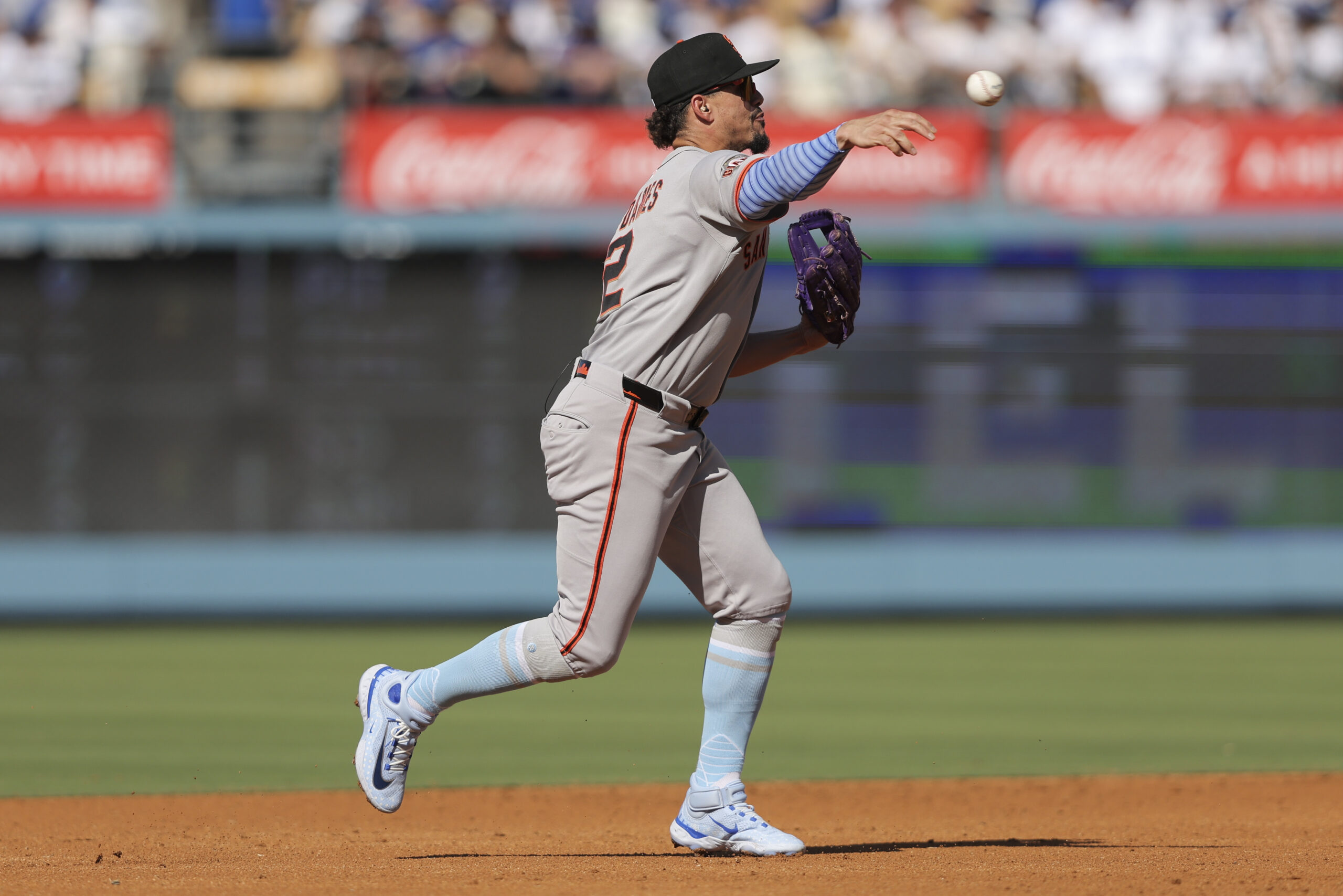 San Francisco Giants shortstop Willy Adames throws to first base...