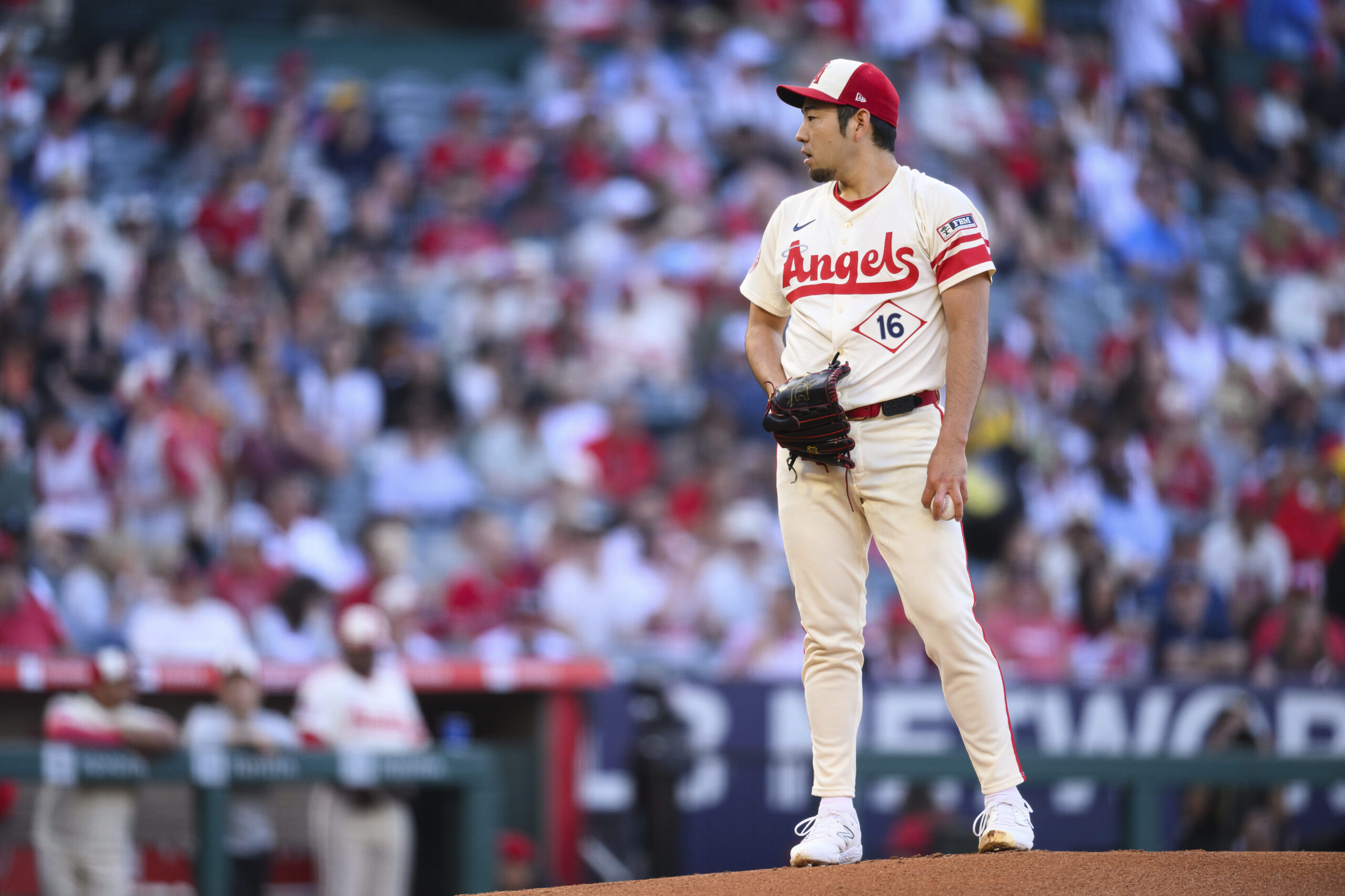 Angels starting pitcher Yusei Kikuchi looks toward the plate before...
