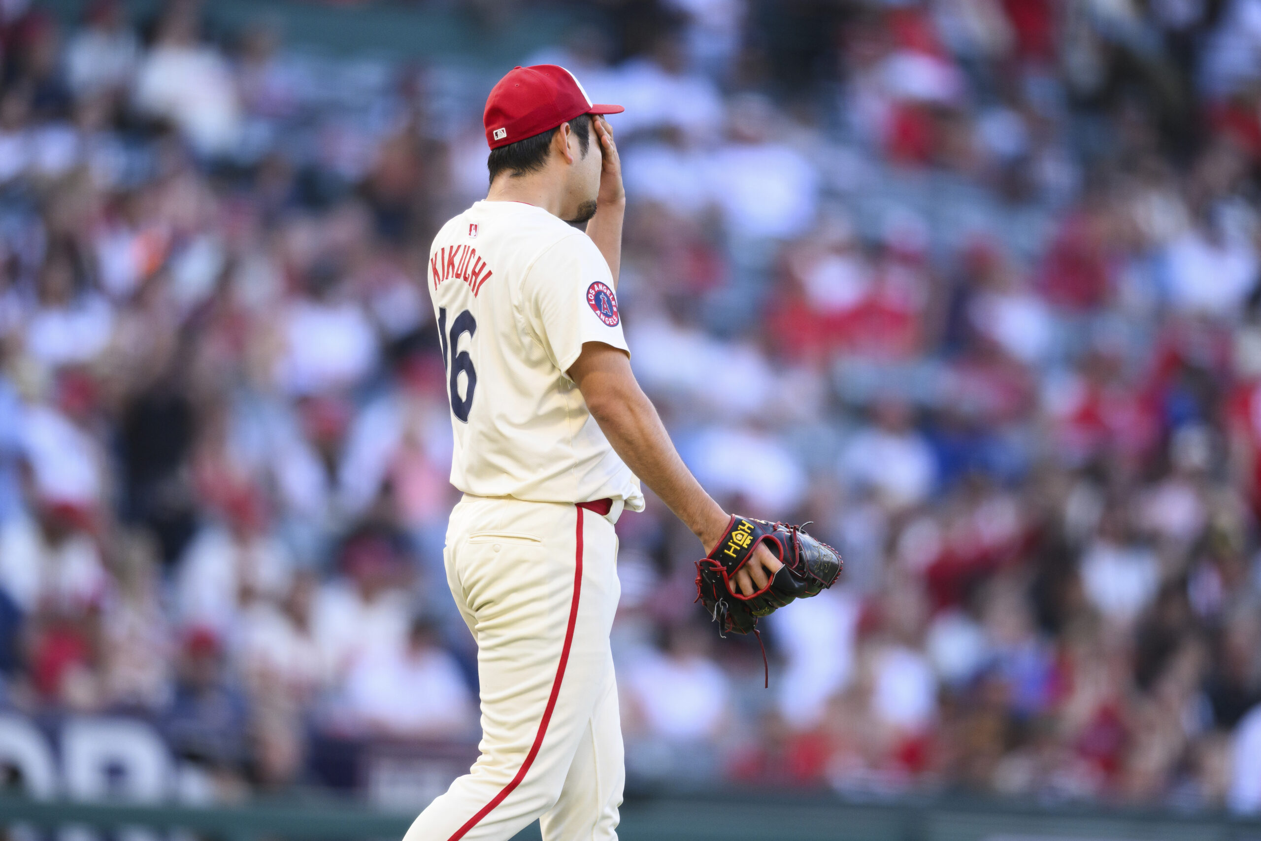 Angels starting pitcher Yusei Kikuchi reacts after giving up a...