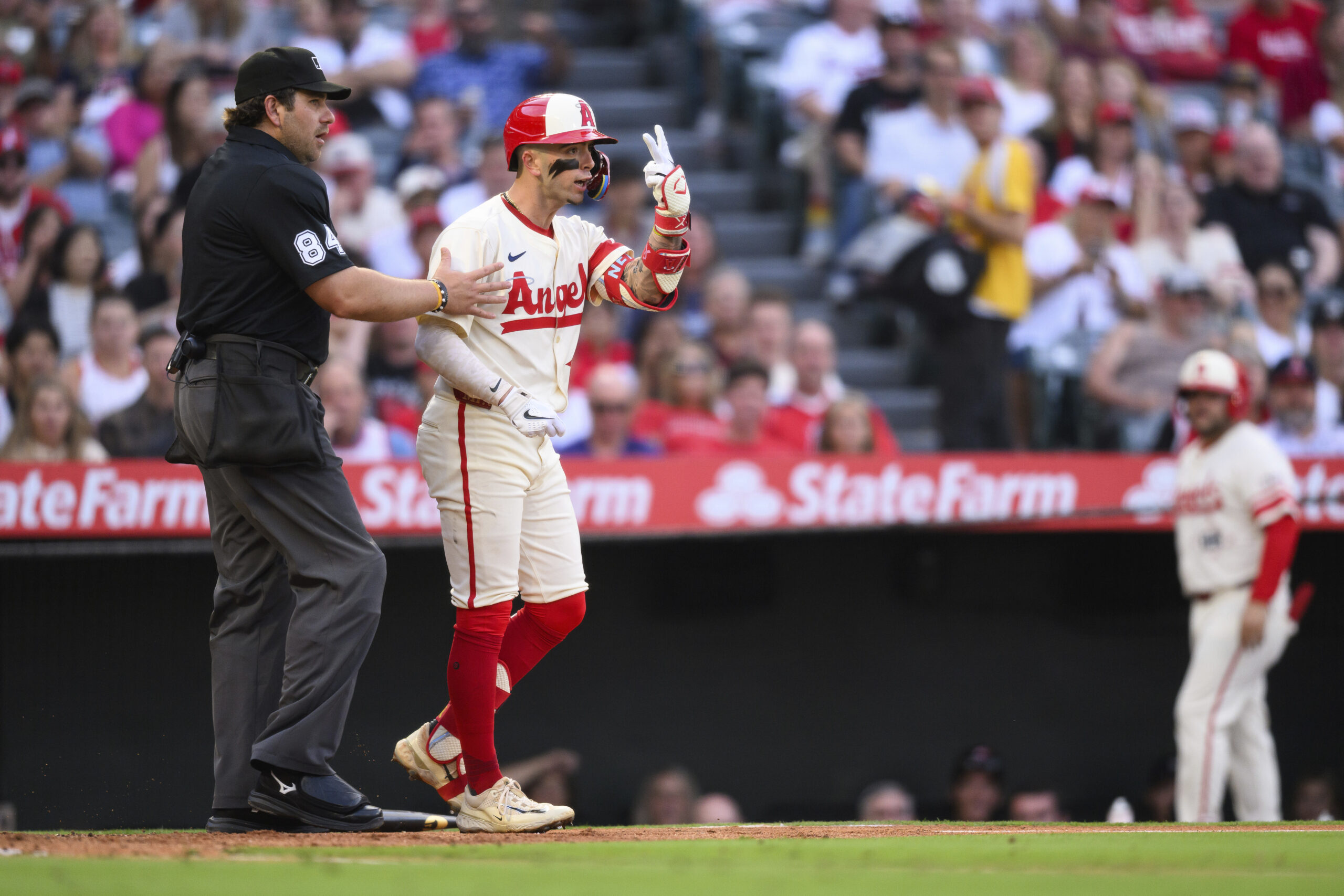 The Angels’ Zach Neto, right, gestures toward Houston Astros starting...