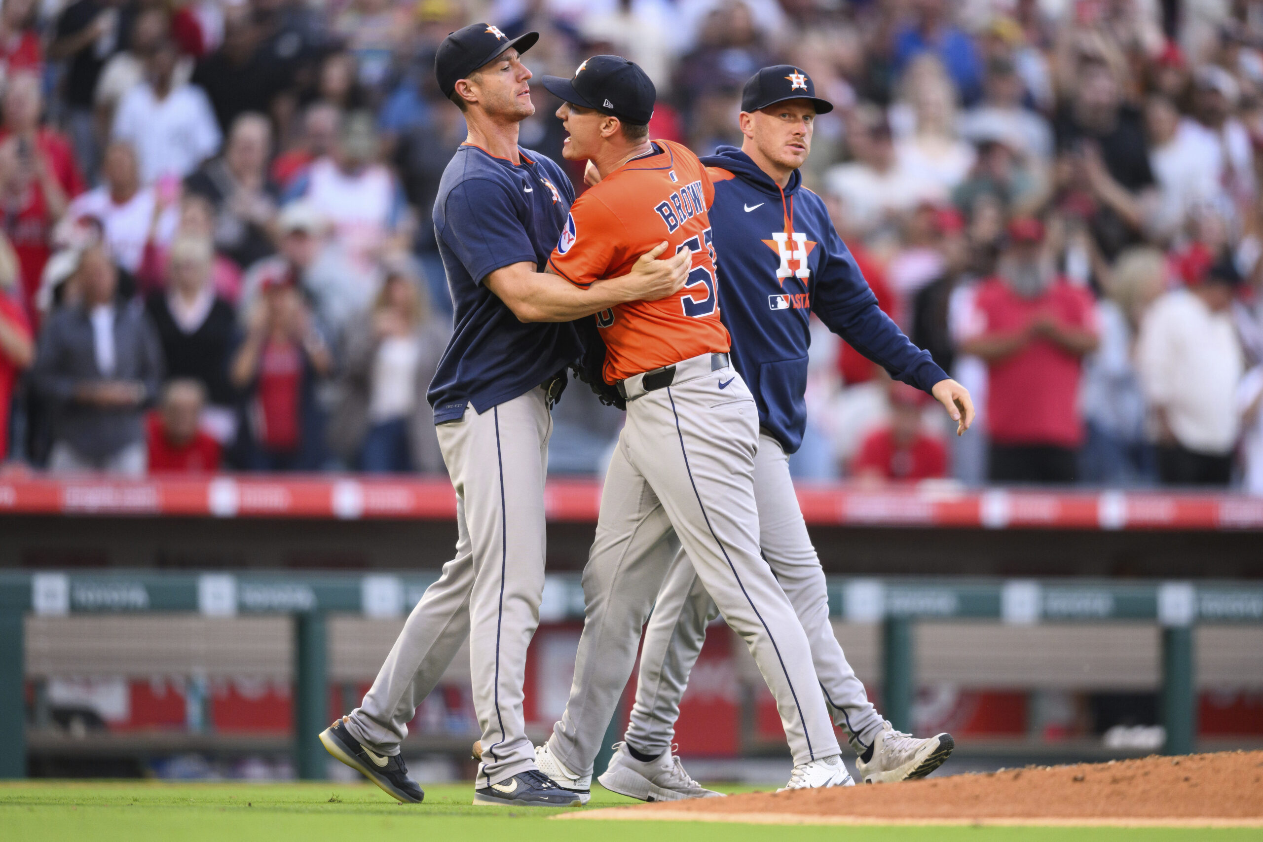 Houston Astros starting pitcher Hunter Brown, center, yells toward home...