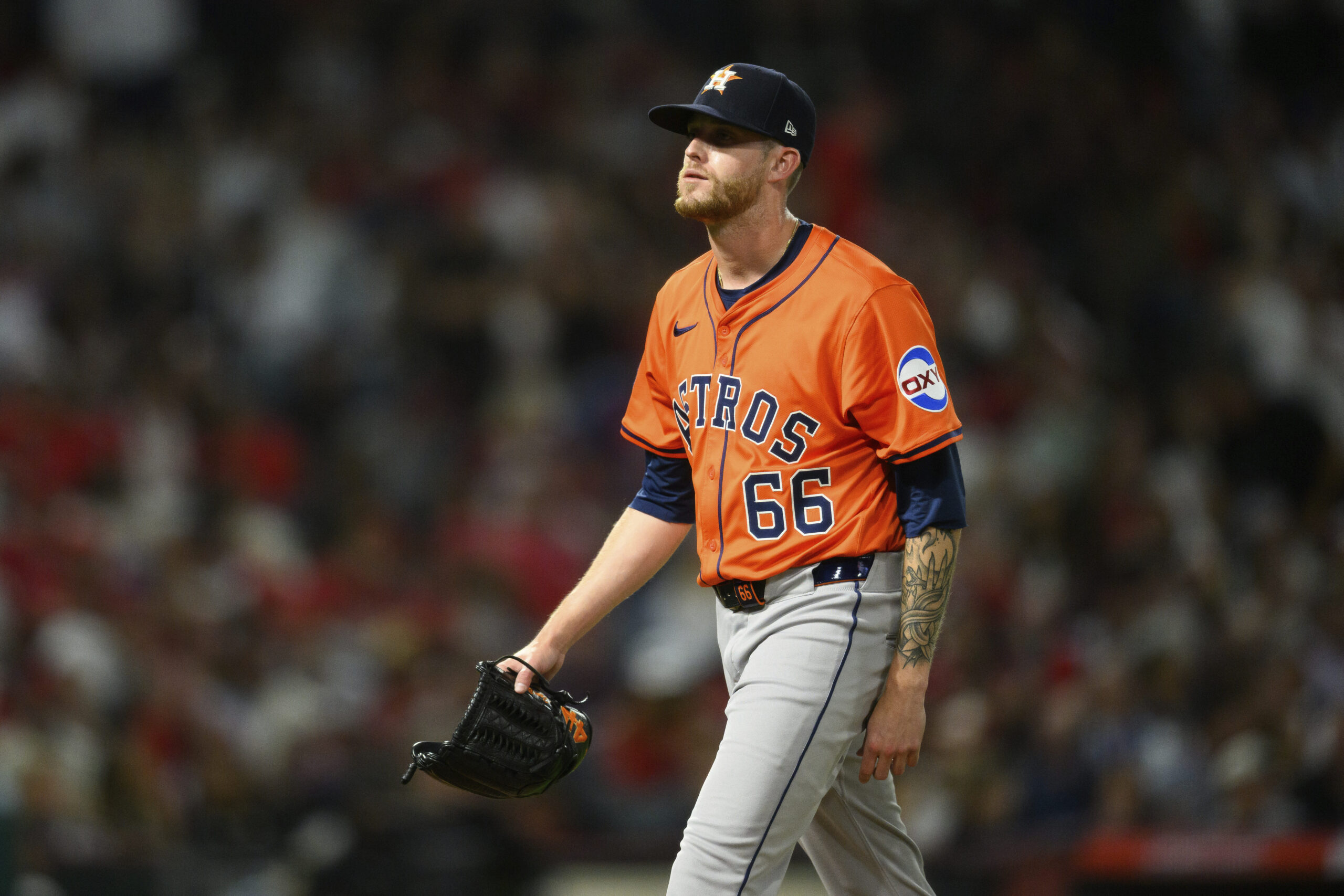 Houston Astros relief pitcher Shawn Dubin walks off the field...