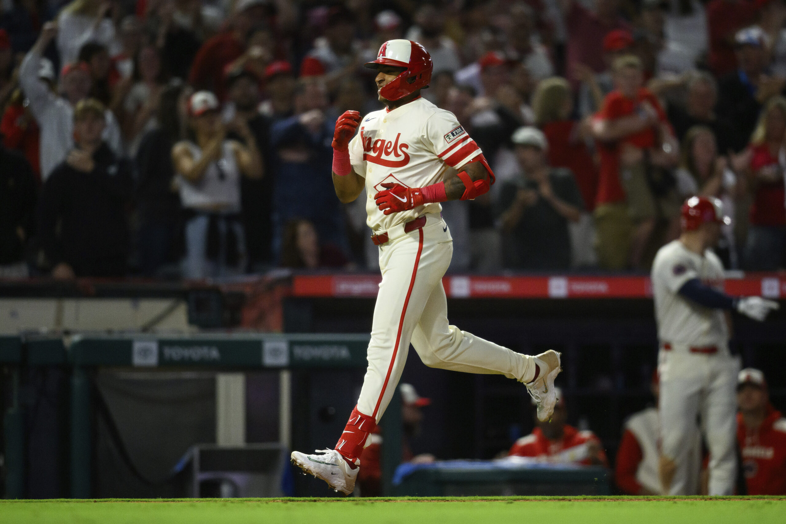 The Angels’ Christian Moore runs the bases after hitting his...