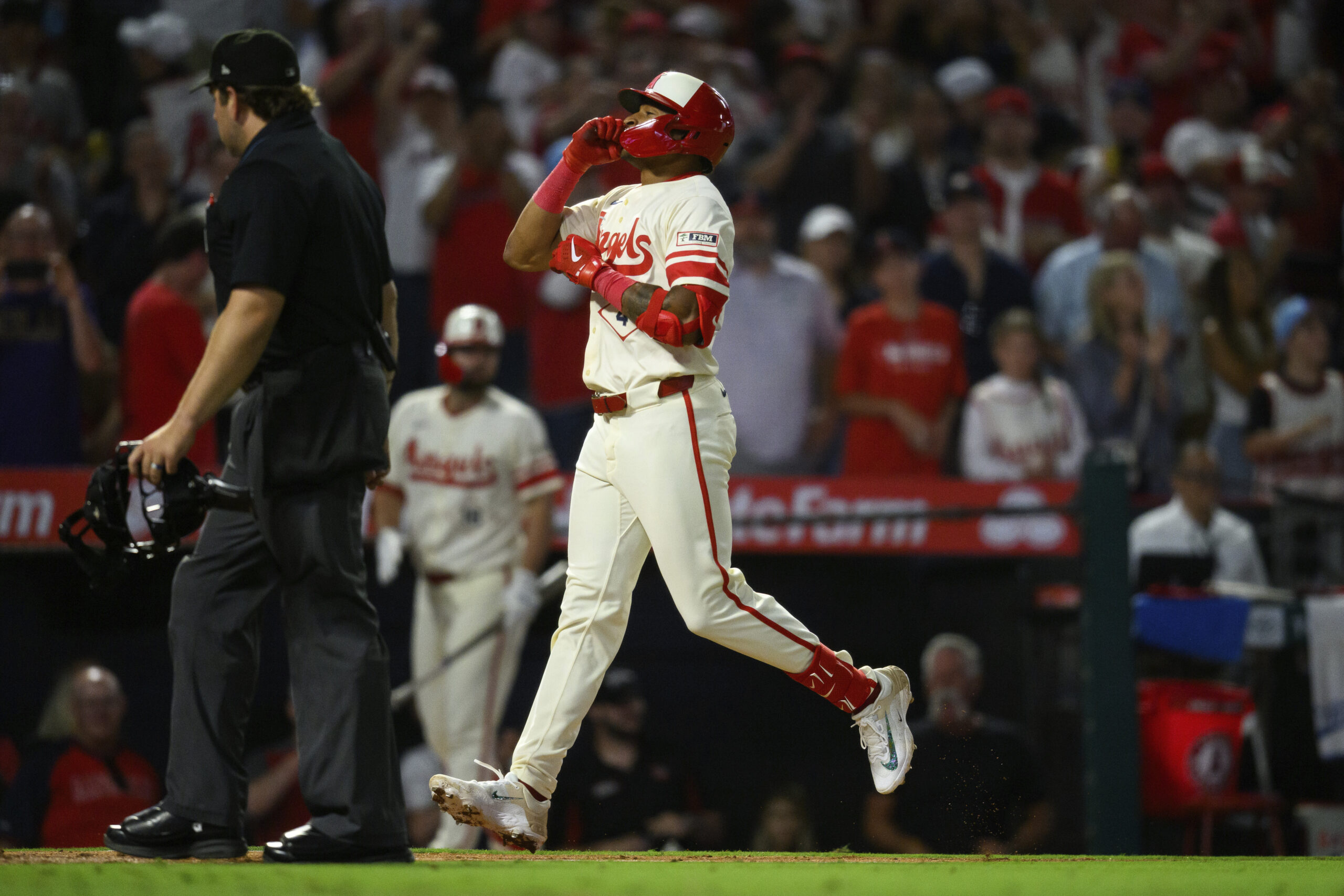The Angels’ Christian Moore runs the bases after hitting his...