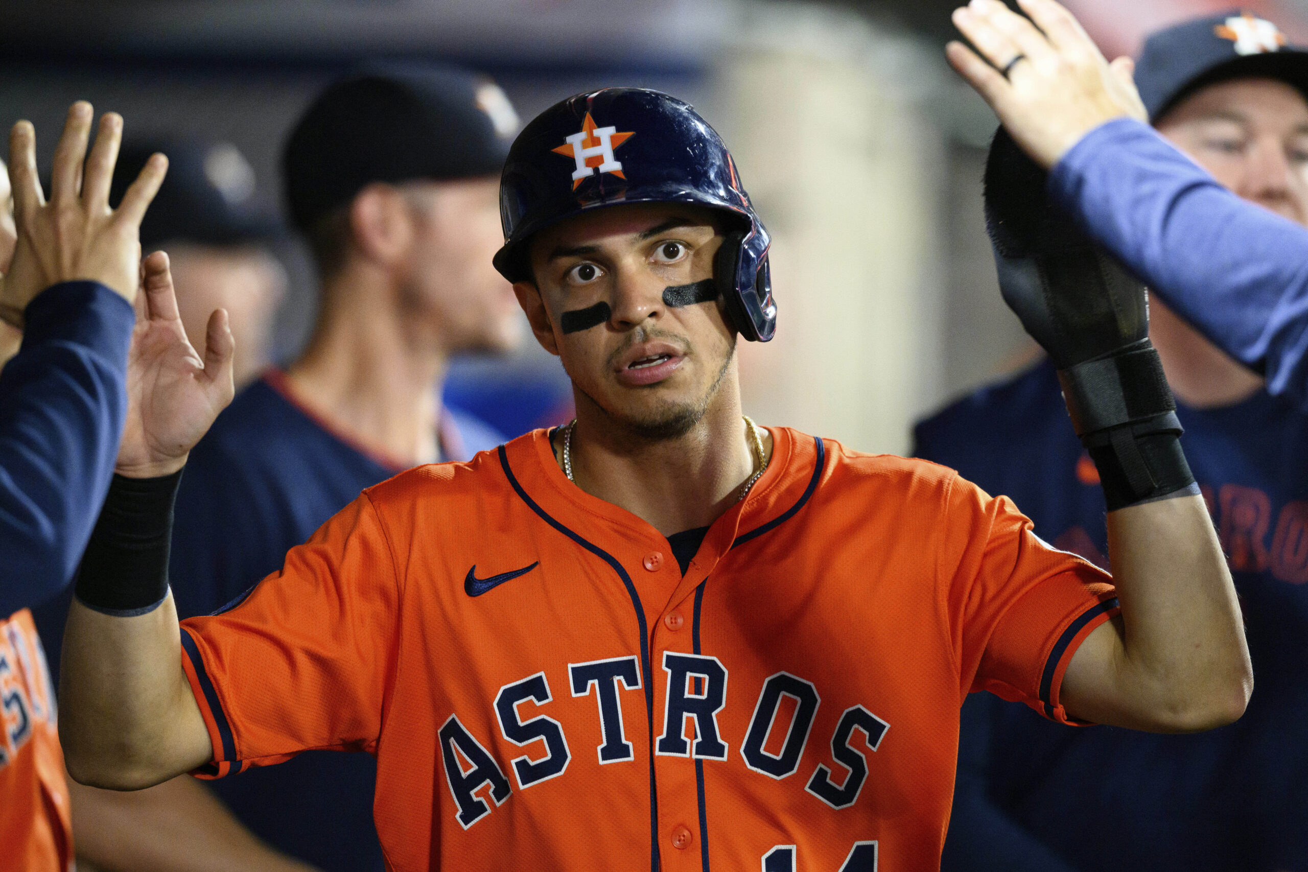 The Houston Astros’ Mauricio Dubón celebrates with teammates in the...