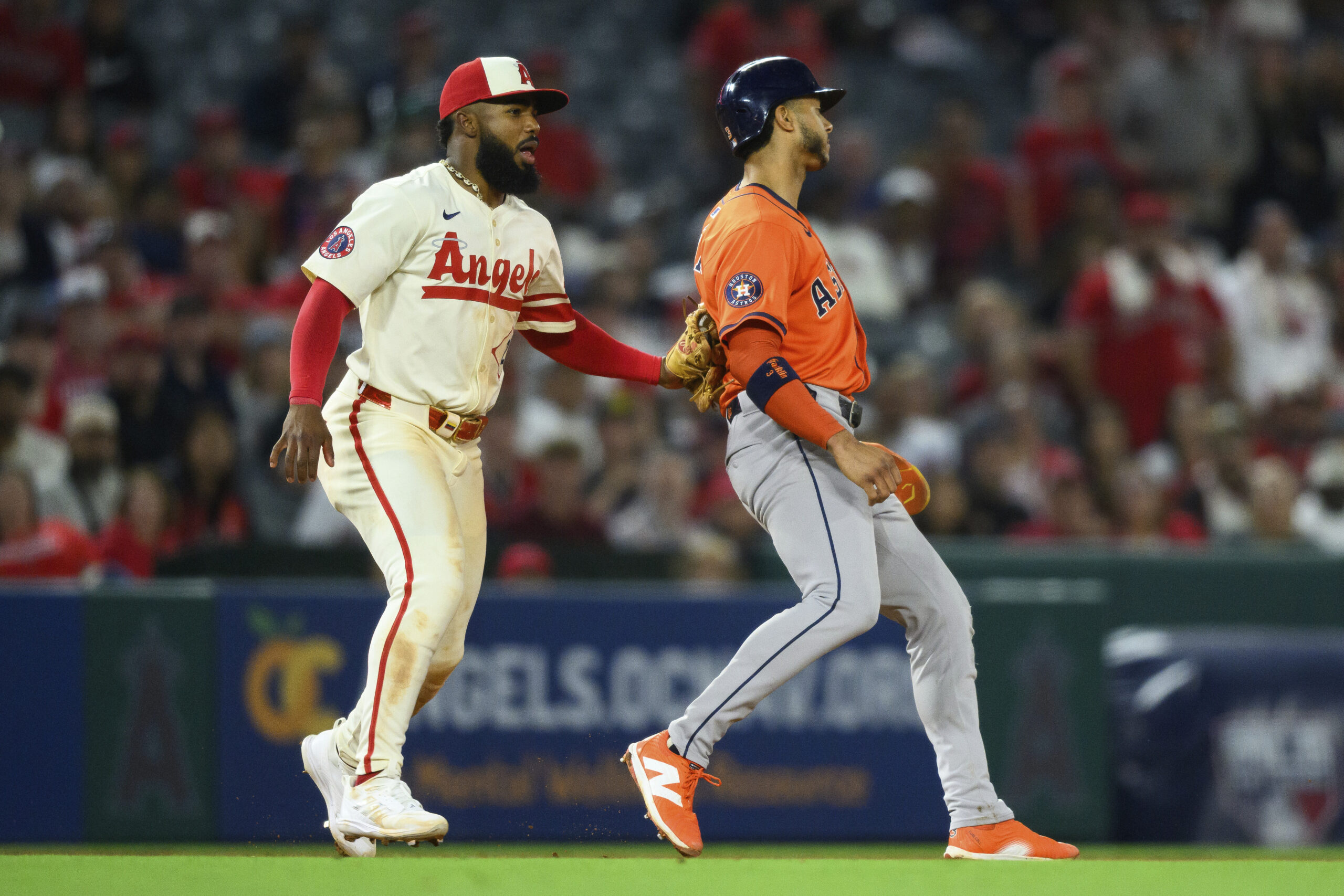 The Houston Astros’ Jeremy Peña, right, is picked off and...