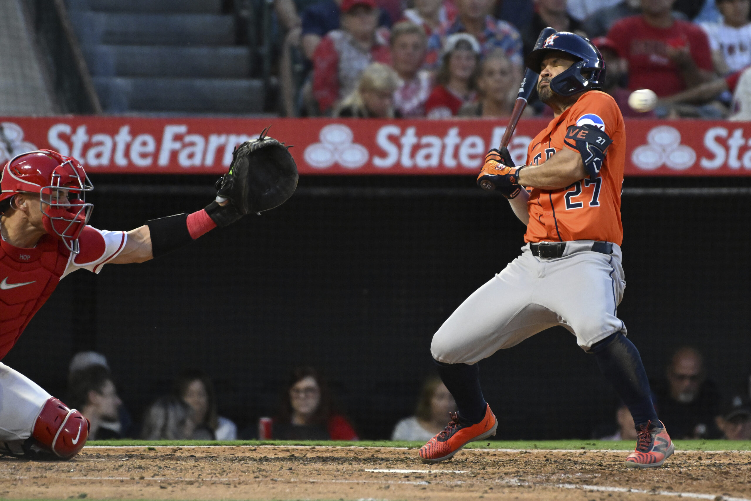 Houston Astros’ Jose Altuve (27) avoids a pitch aby the...