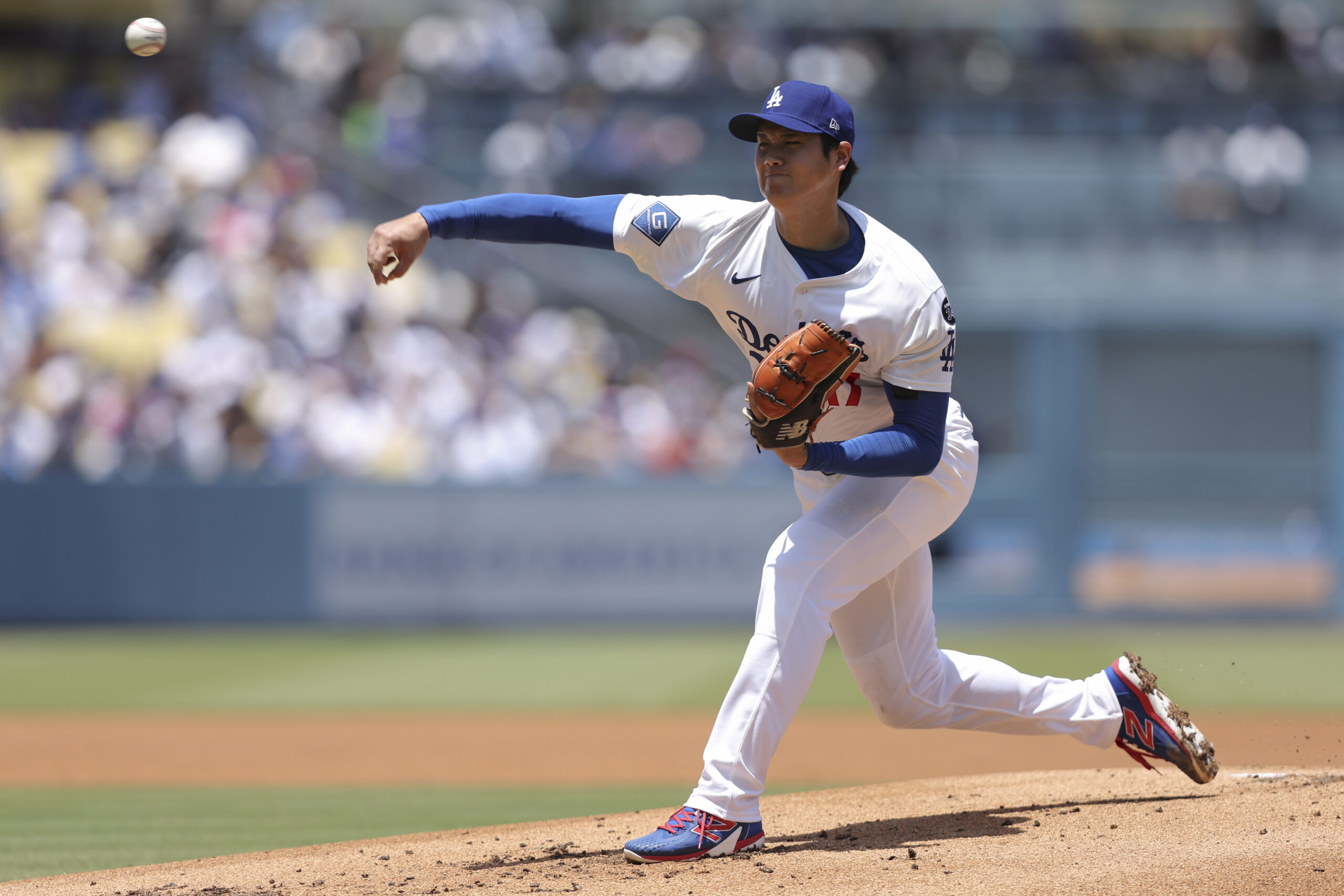 Dodgers starting pitcher Shohei Ohtani throws to a Washington Nationals...
