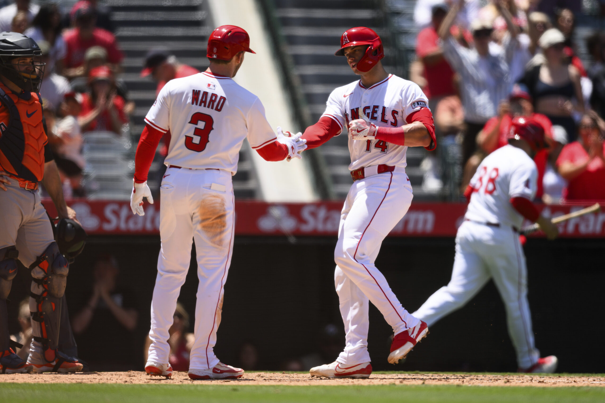 Angels’ Logan O’Hoppe celebrates with Taylor Ward after hitting a...