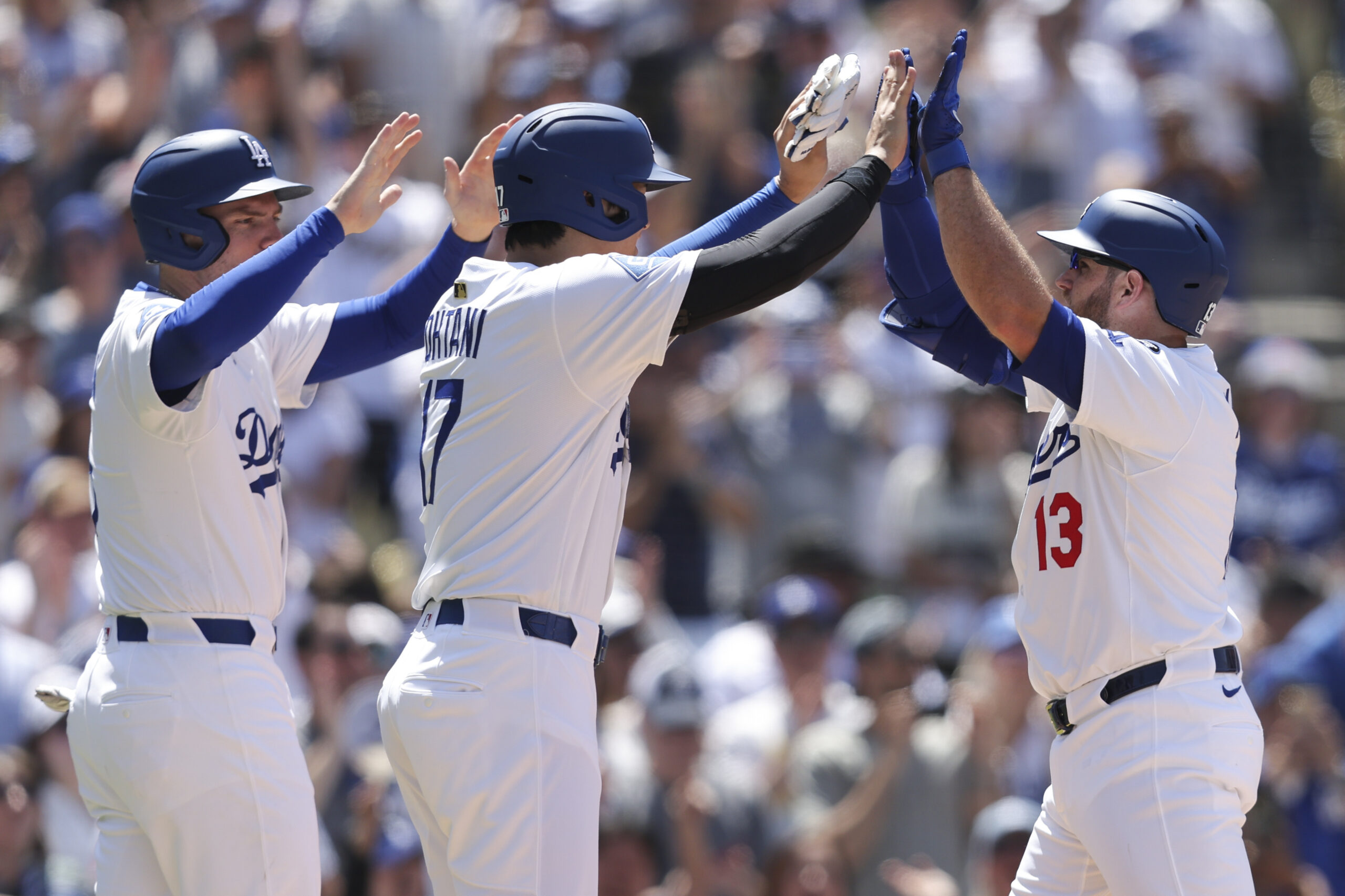 Dodgers’ Max Muncy celebrates with Shohei Ohtani, left, as Freddie...