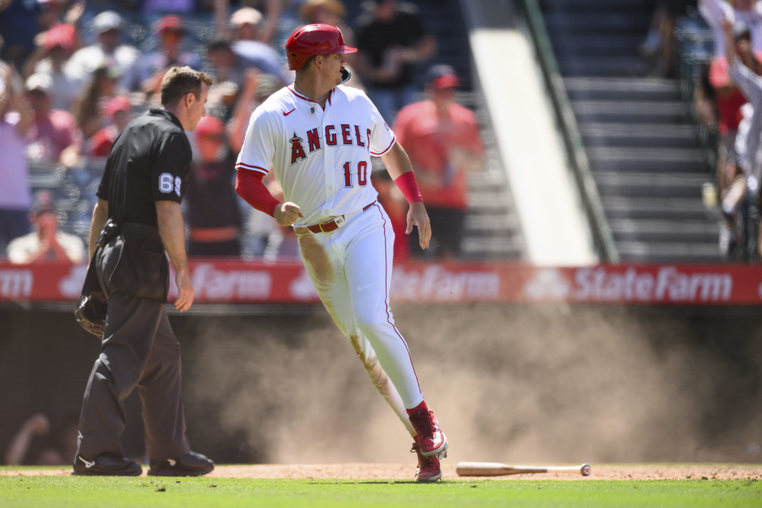 Angels’ Kevin Newman looks back after scoring during the seventh...
