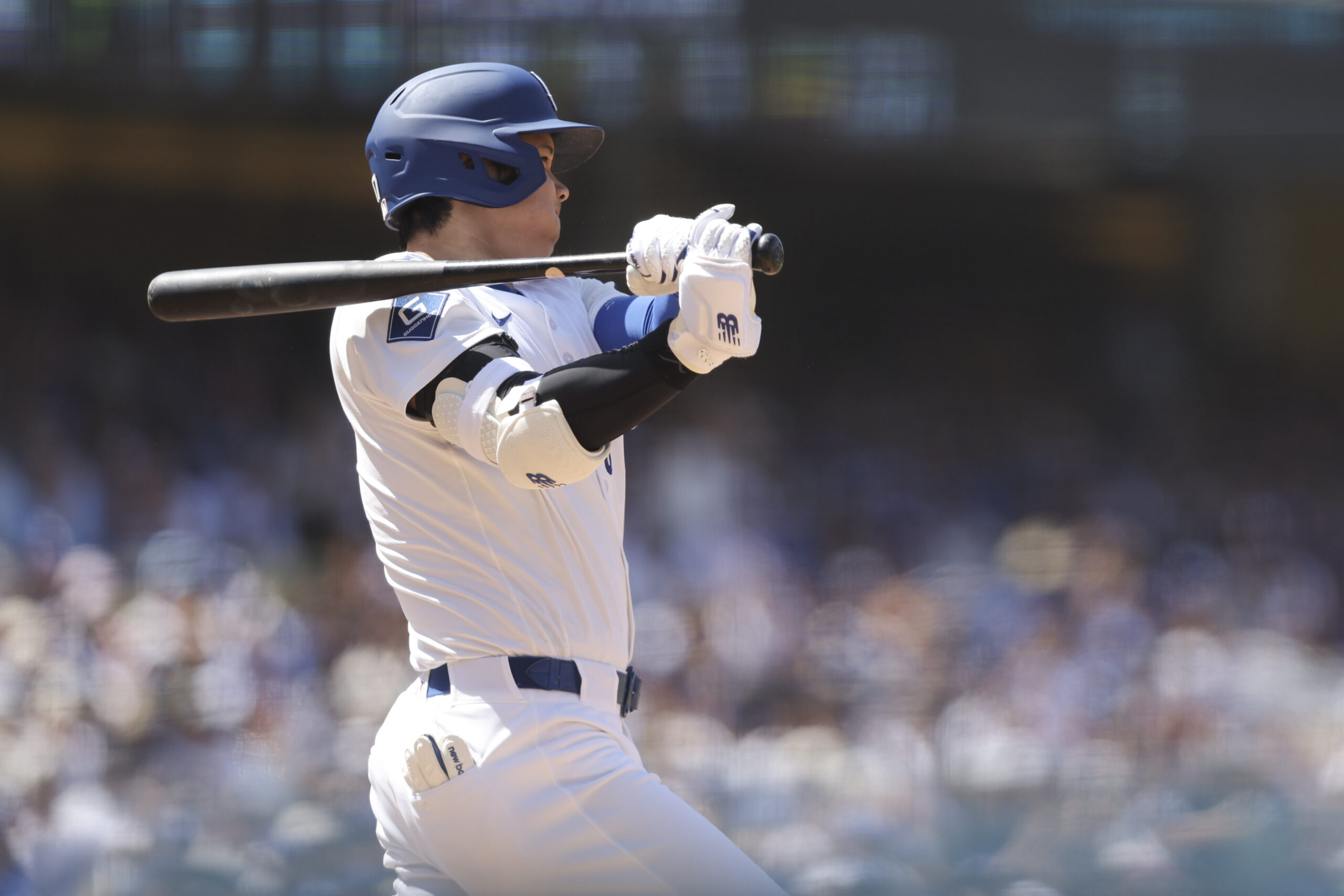 Dodgers’ Shohei Ohtani follows through on an RBI triple during...