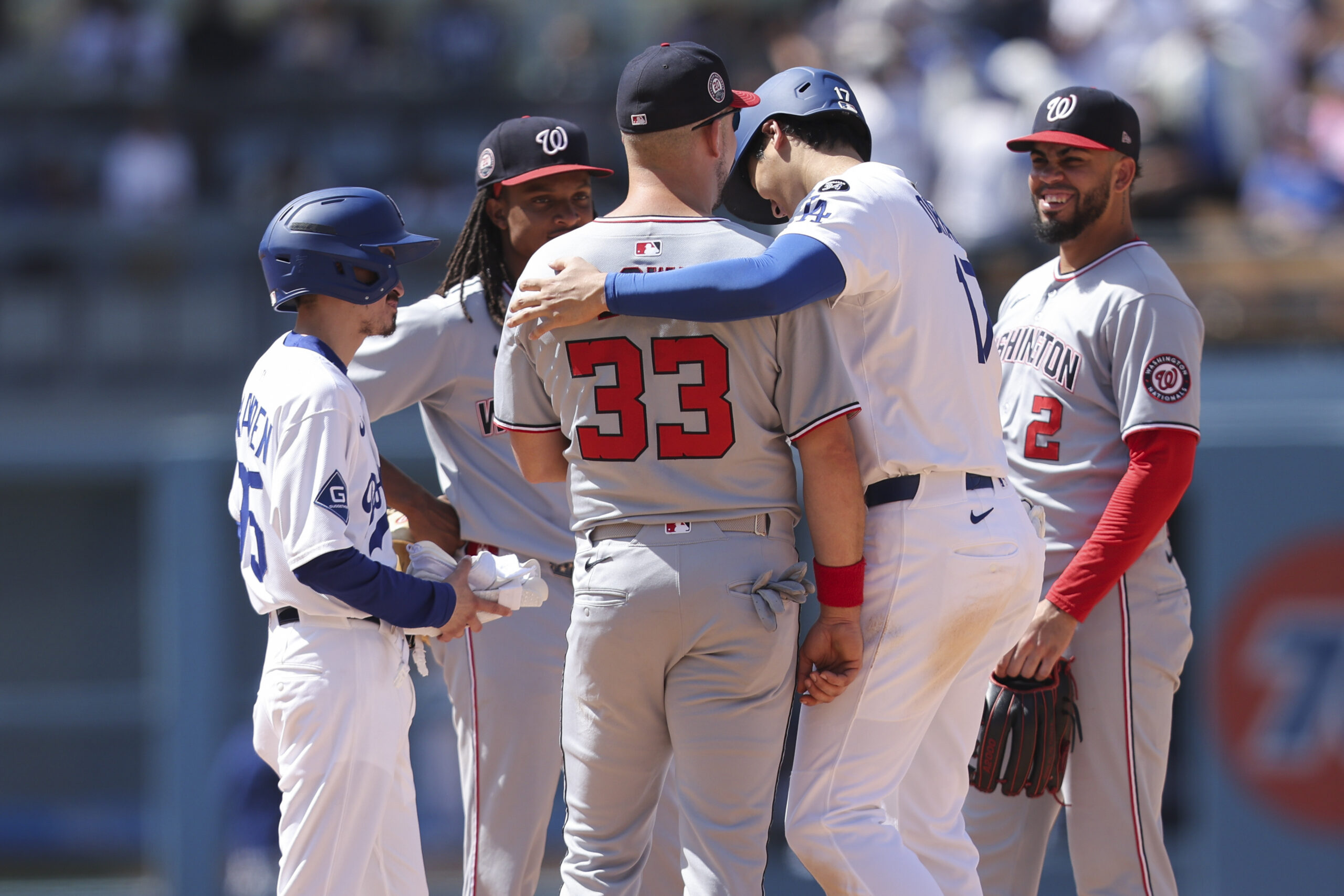 Dodgers’ Shohei Ohtani, right, and Washington Nationals first baseman Nathaniel...