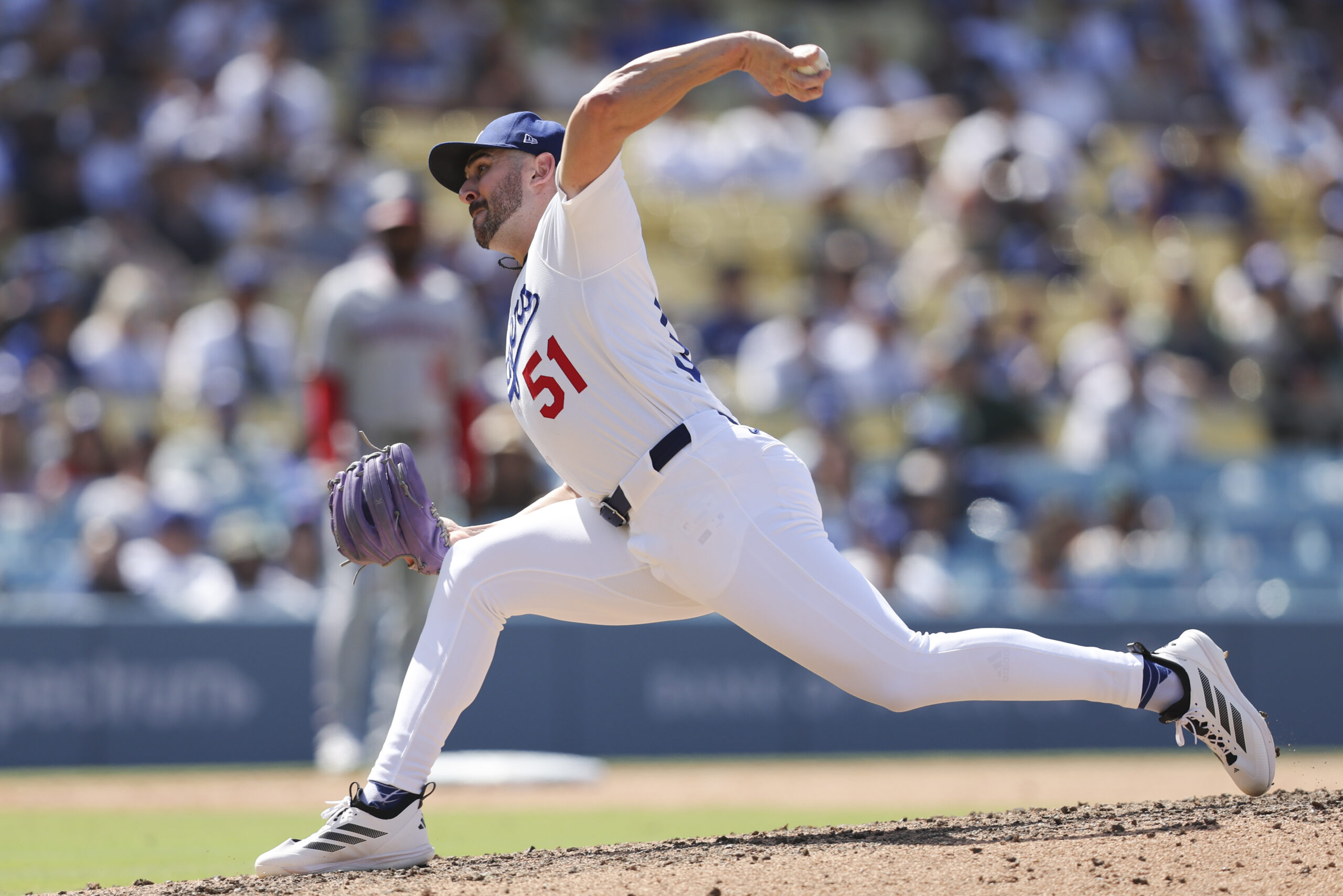 Dodgers pitcher Alex Vesia (51) throws to a Washington Nationals...