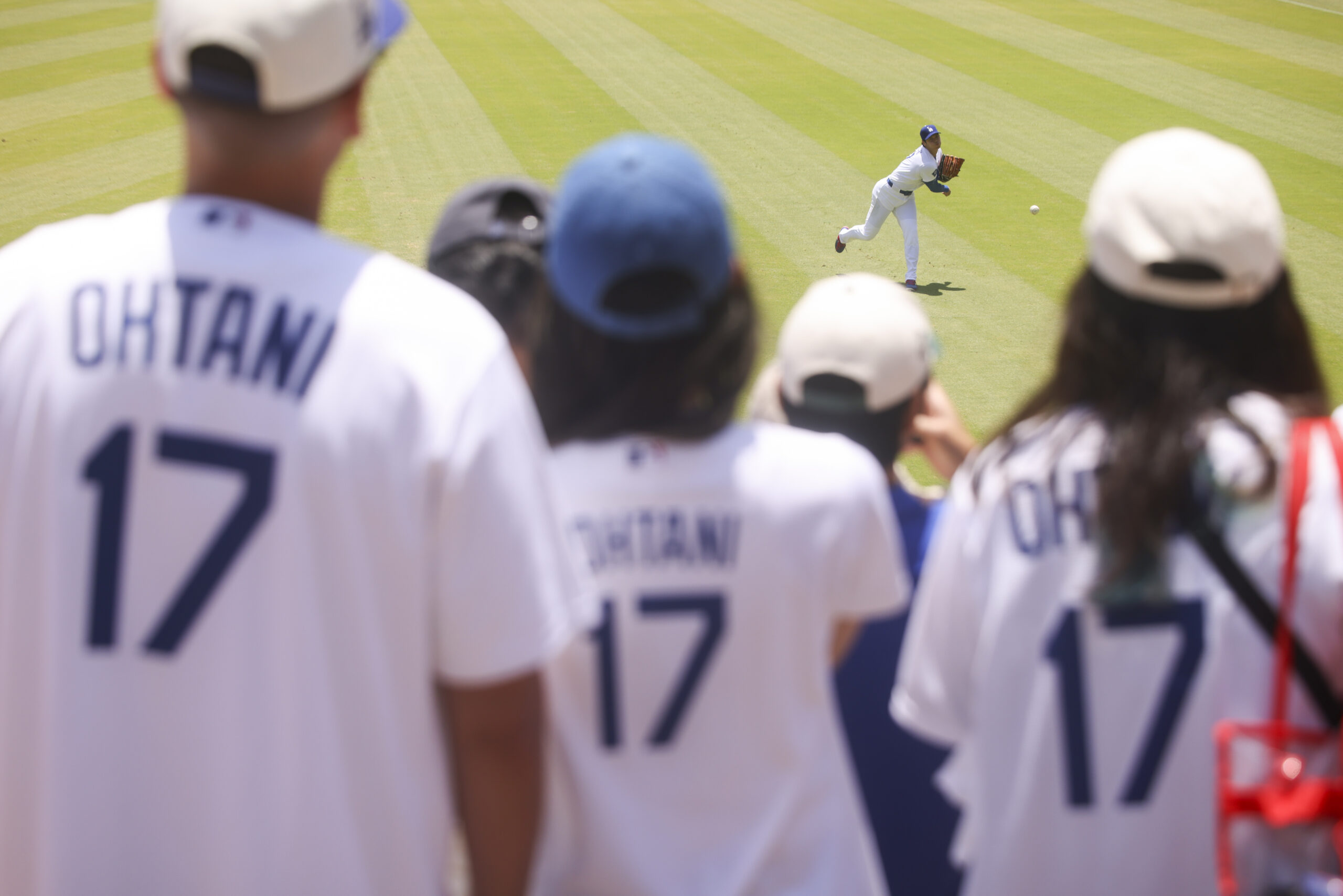 Dodgers starting pitcher Shohei Ohtani warms up before a baseball...