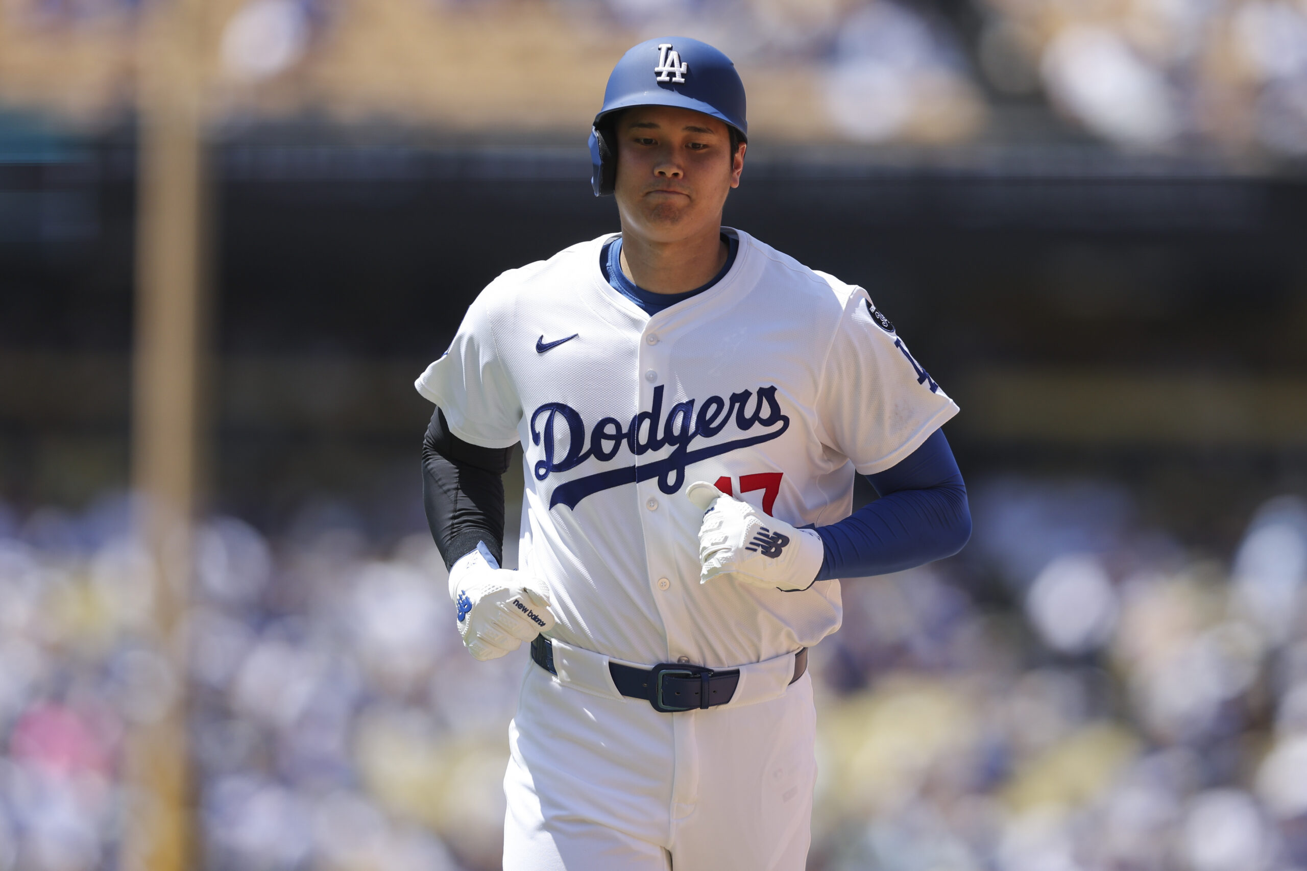 Dodgers’ Shohei Ohtani runs towards first base during the sixth...