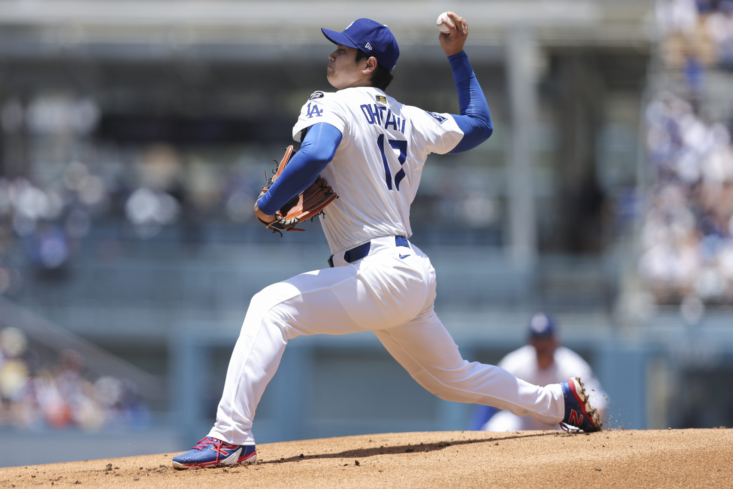Dodgers starting pitcher Shohei Ohtani throws to a Washington Nationals...