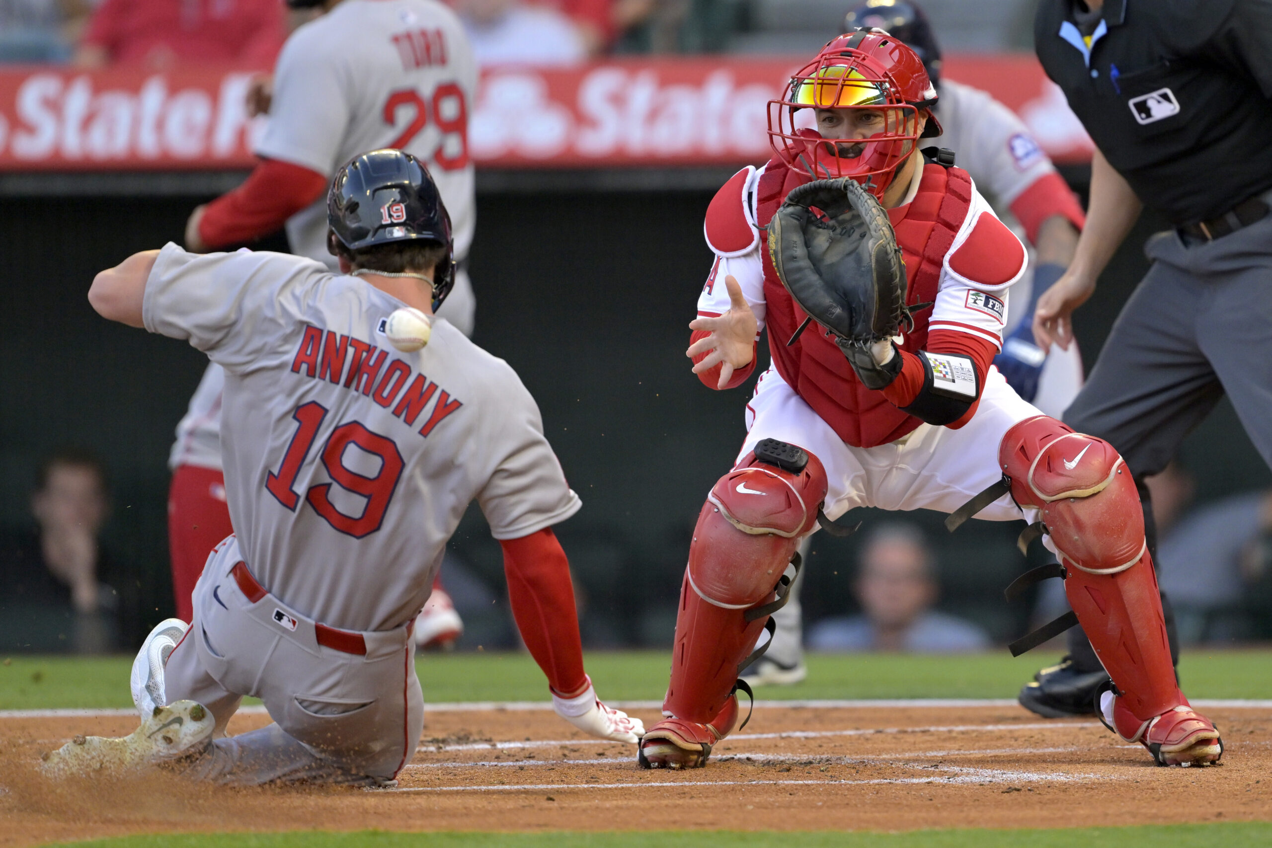 The Boston Red Sox’s Roman Anthony, left, scores a run...