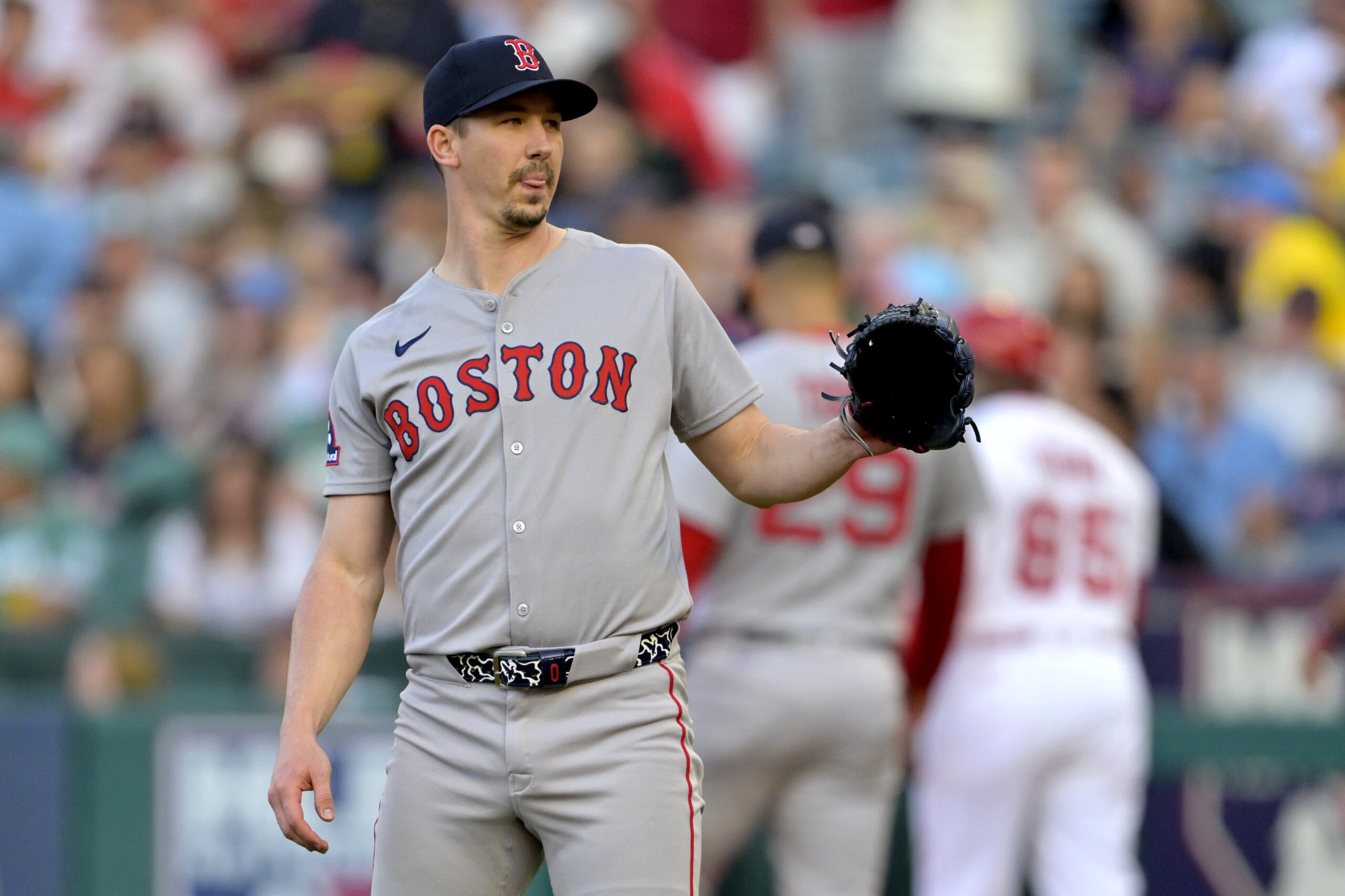 Boston Red Sox starting pitcher Walker Buehler reacts after giving...