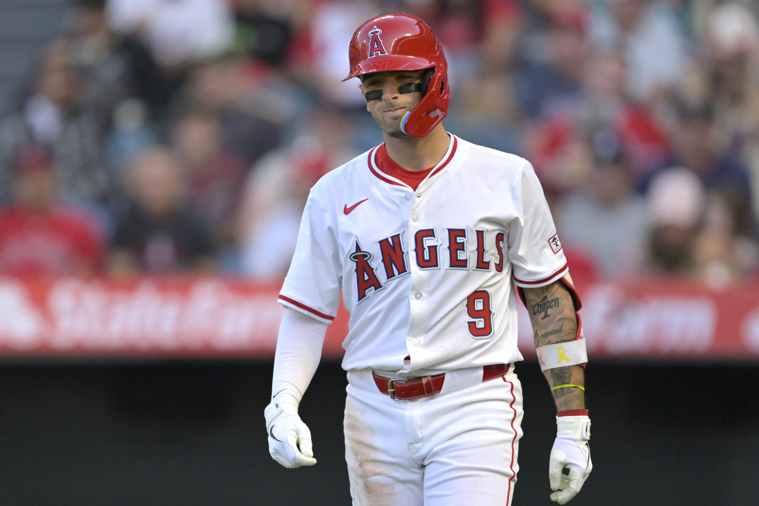 The Angels’ Zach Neto reacts after being hit by a...
