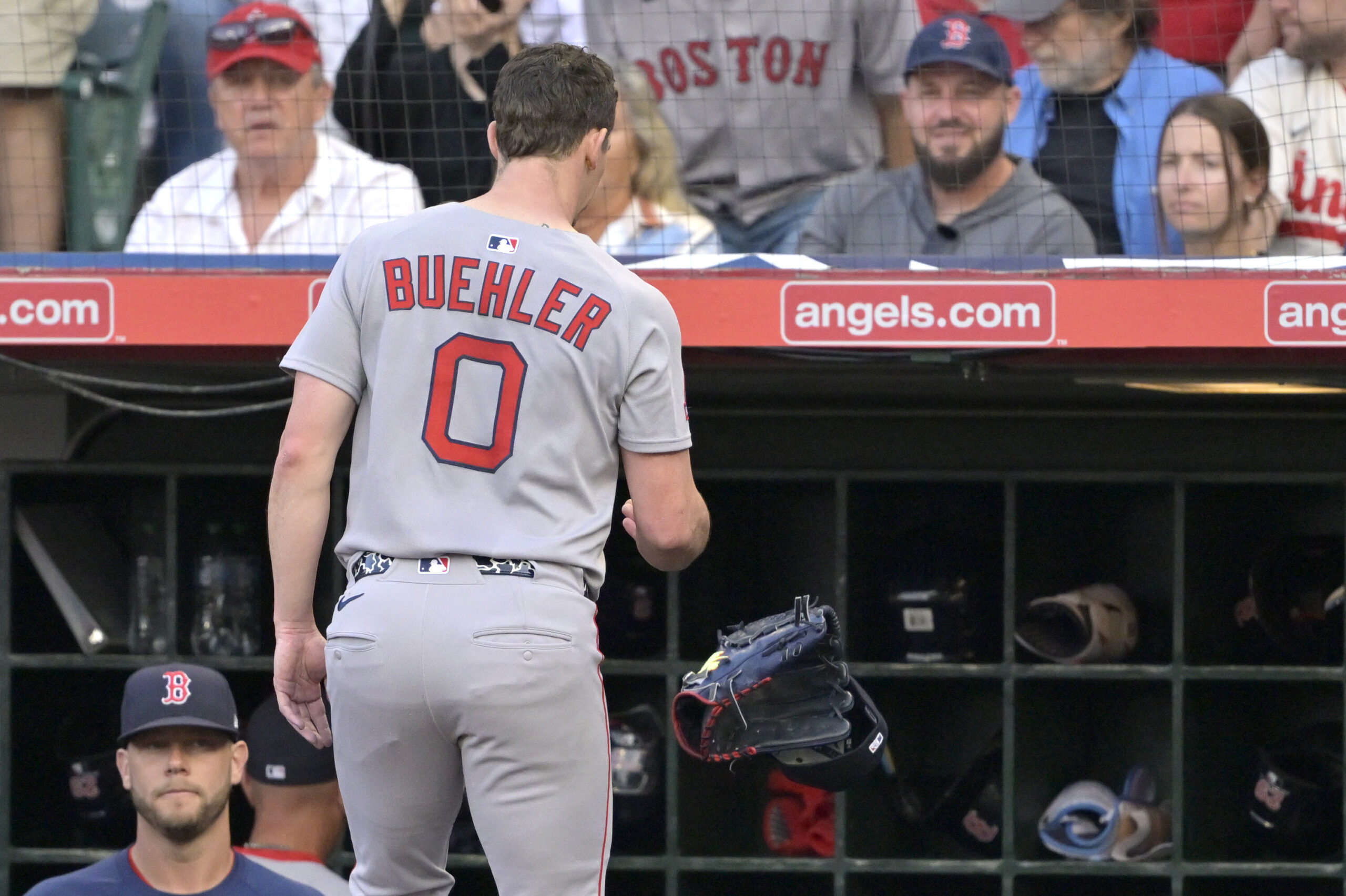 Boston Red Sox starting pitcher Walker Buehler tosses his glove...