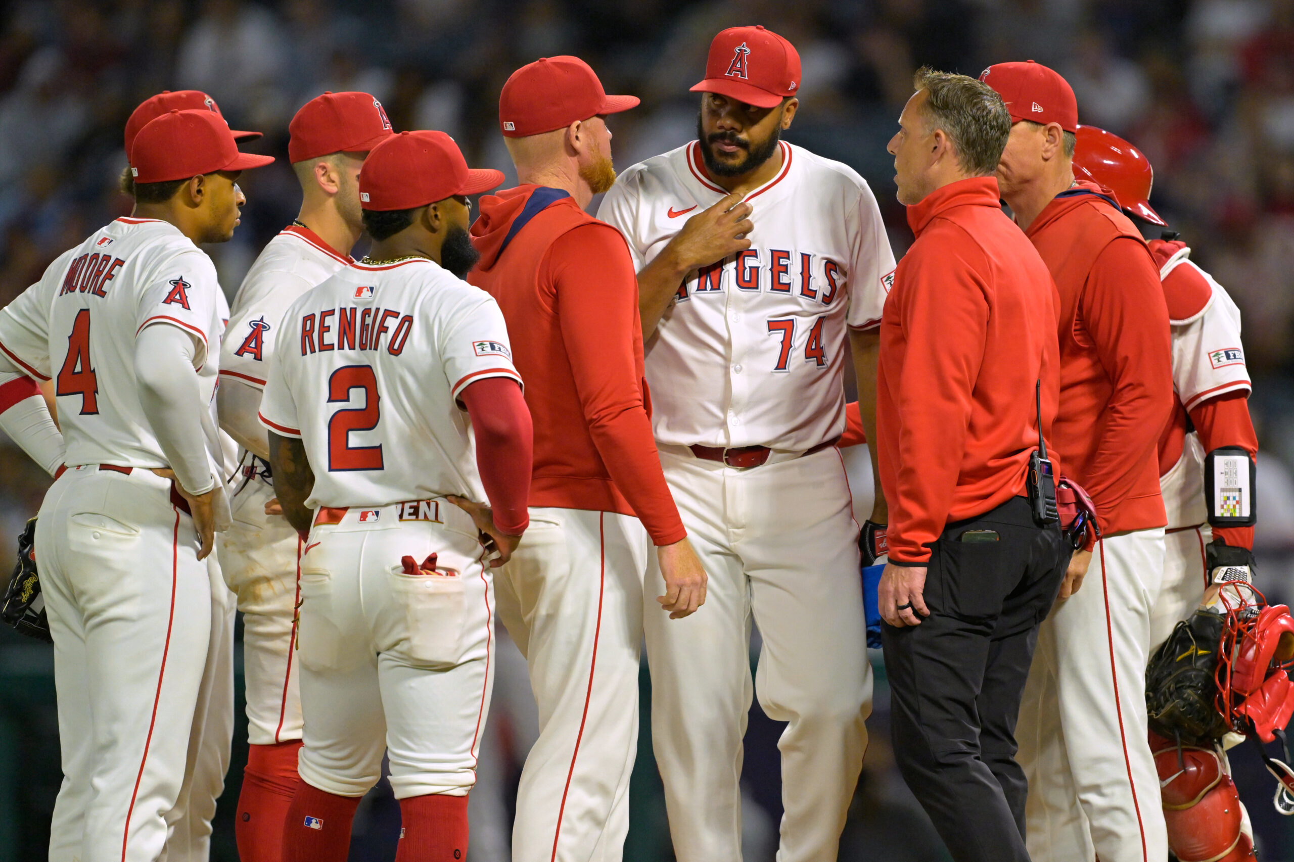 Angels relief pitcher Kenley Jansen (74) talks with pitching coach...