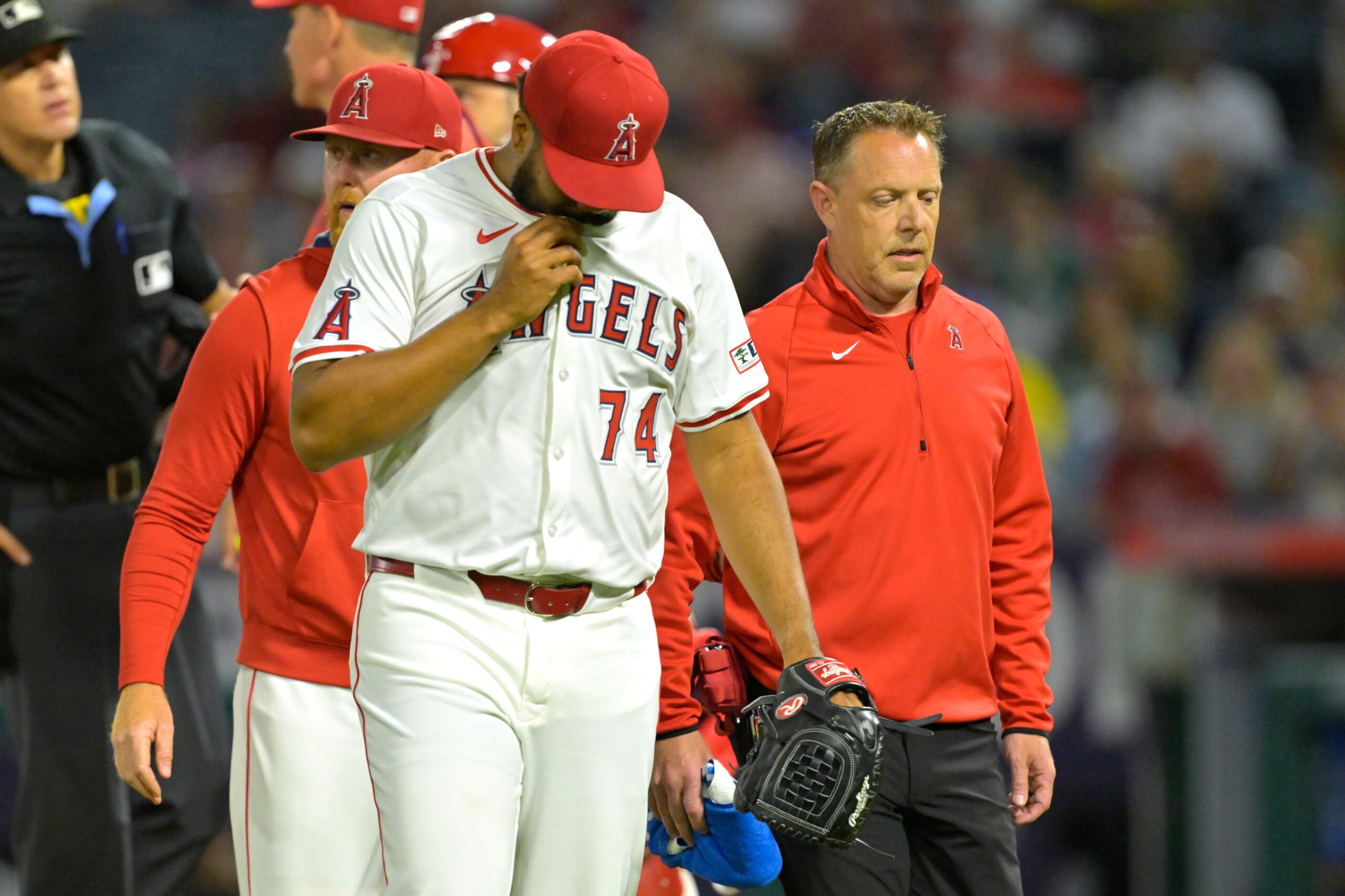 Angels relief pitcher Kenley Jansen walks with pitching coach Barry...