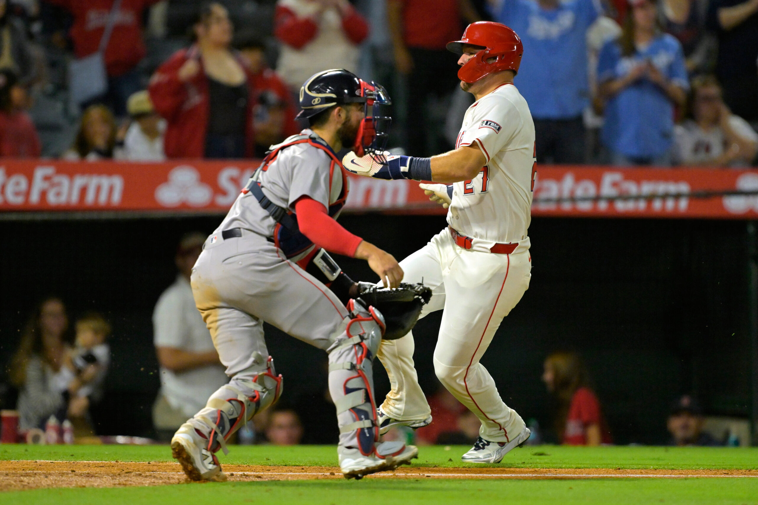 Angels star Mike Trout, right, beats the throw to Boston...