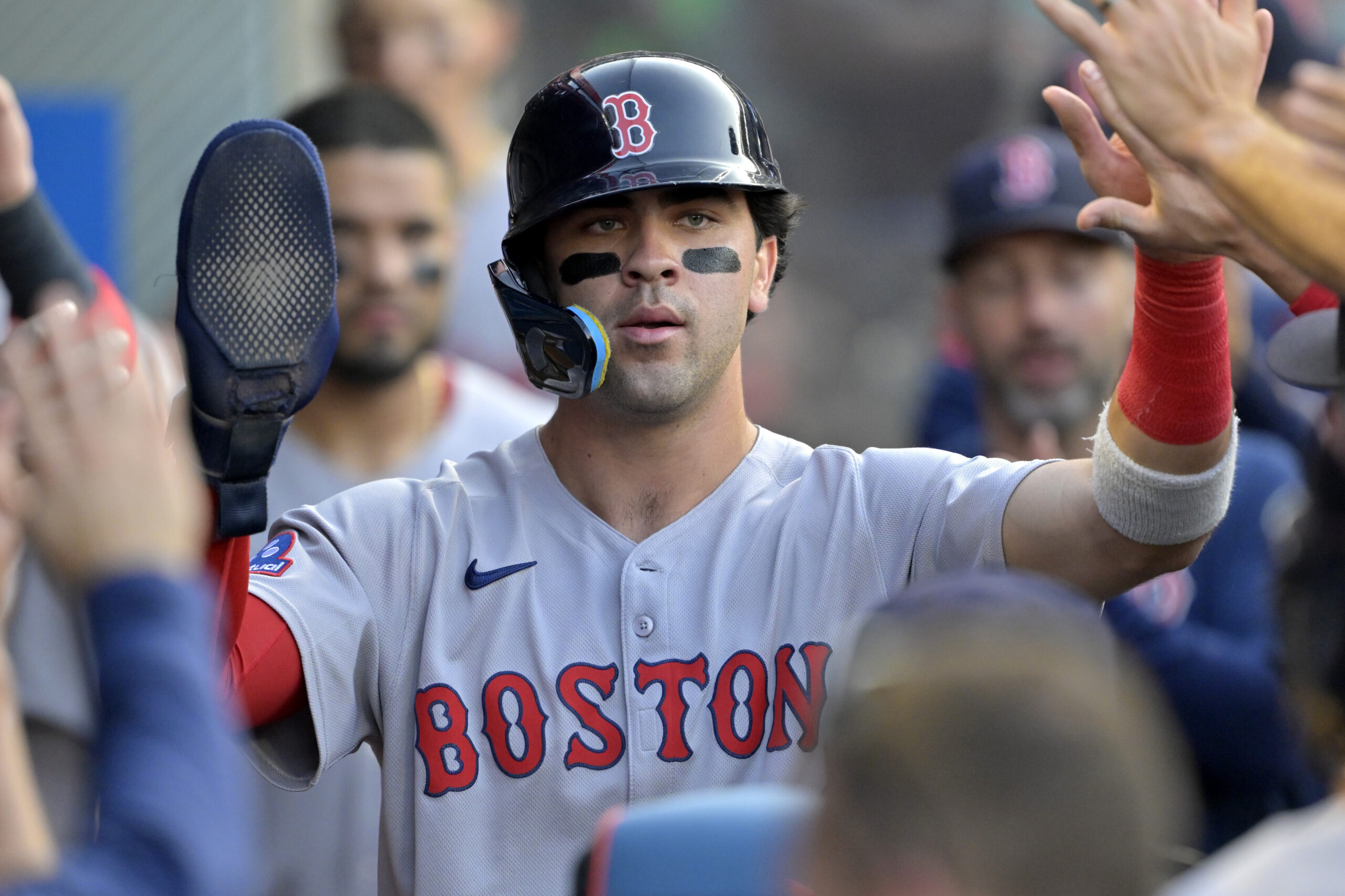 The Boston Red Sox’s Marcelo Mayer is congratulated in the...