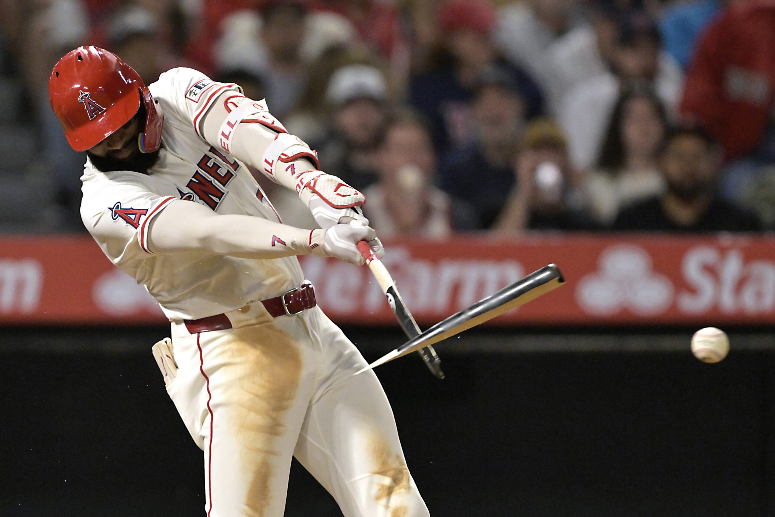 The Angels’ Jo Adell breaks his bat while hitting a...