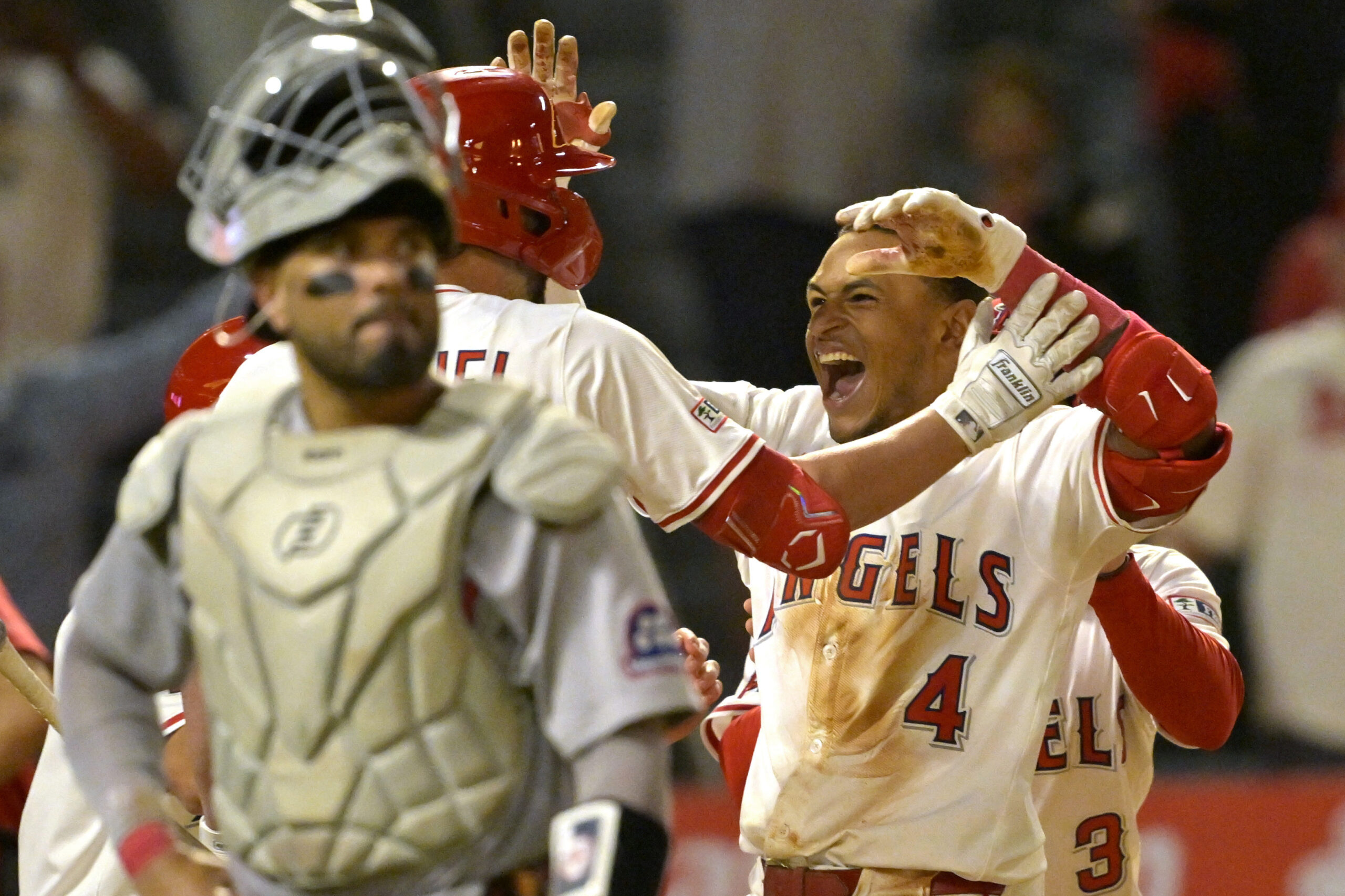 The Angels’ Christian Moore, right, celebrates after hitting a two-run,...