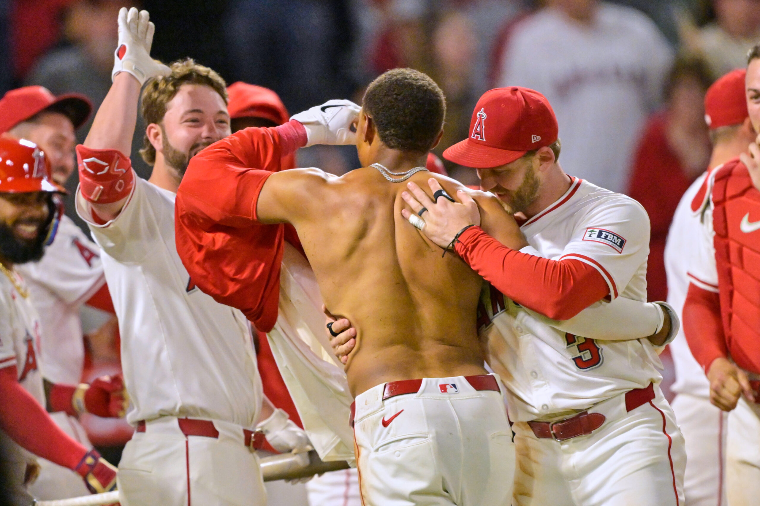 The Angels’ Christian Moore, shirtless, is congratulated by teammates Nolan...