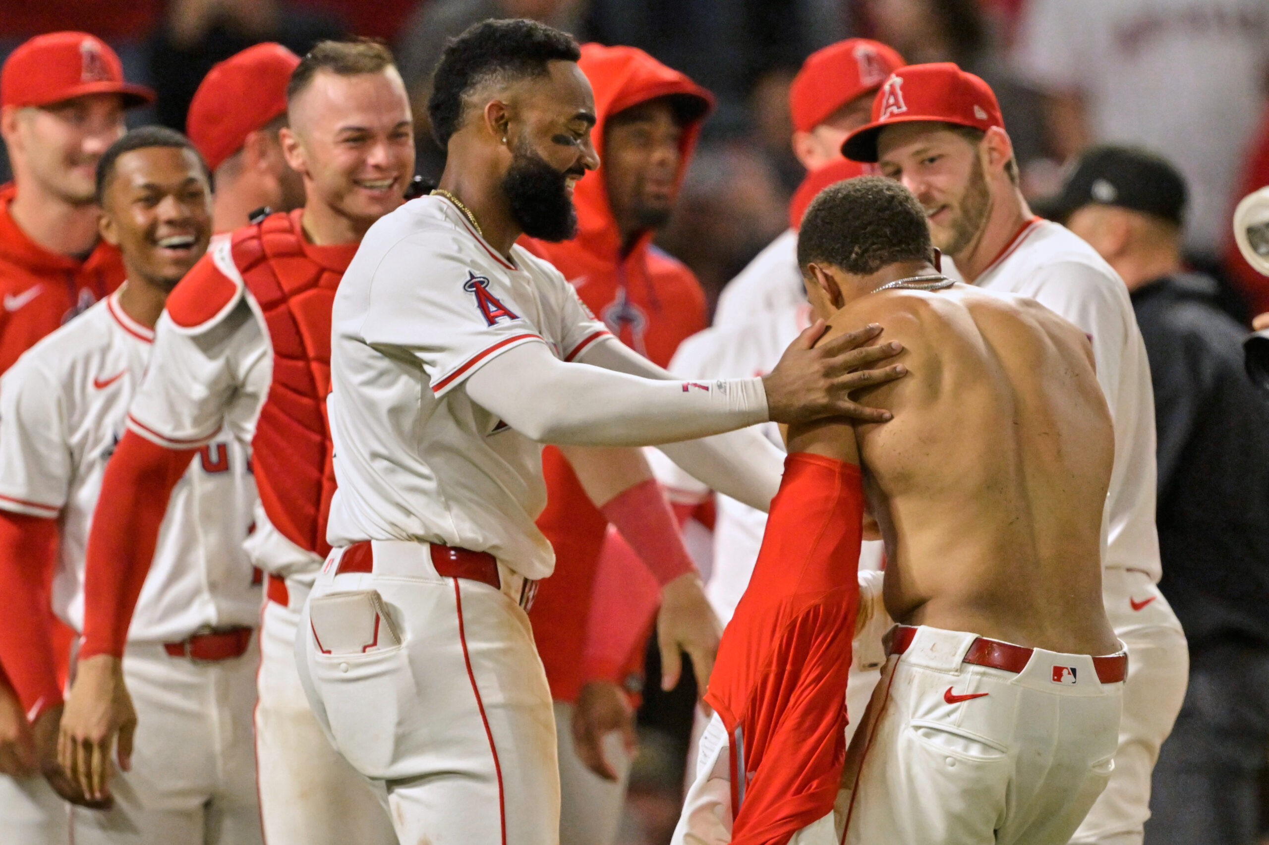 The Angels’ Christian Moore, shirtless, is congratulated by teammates Jo...