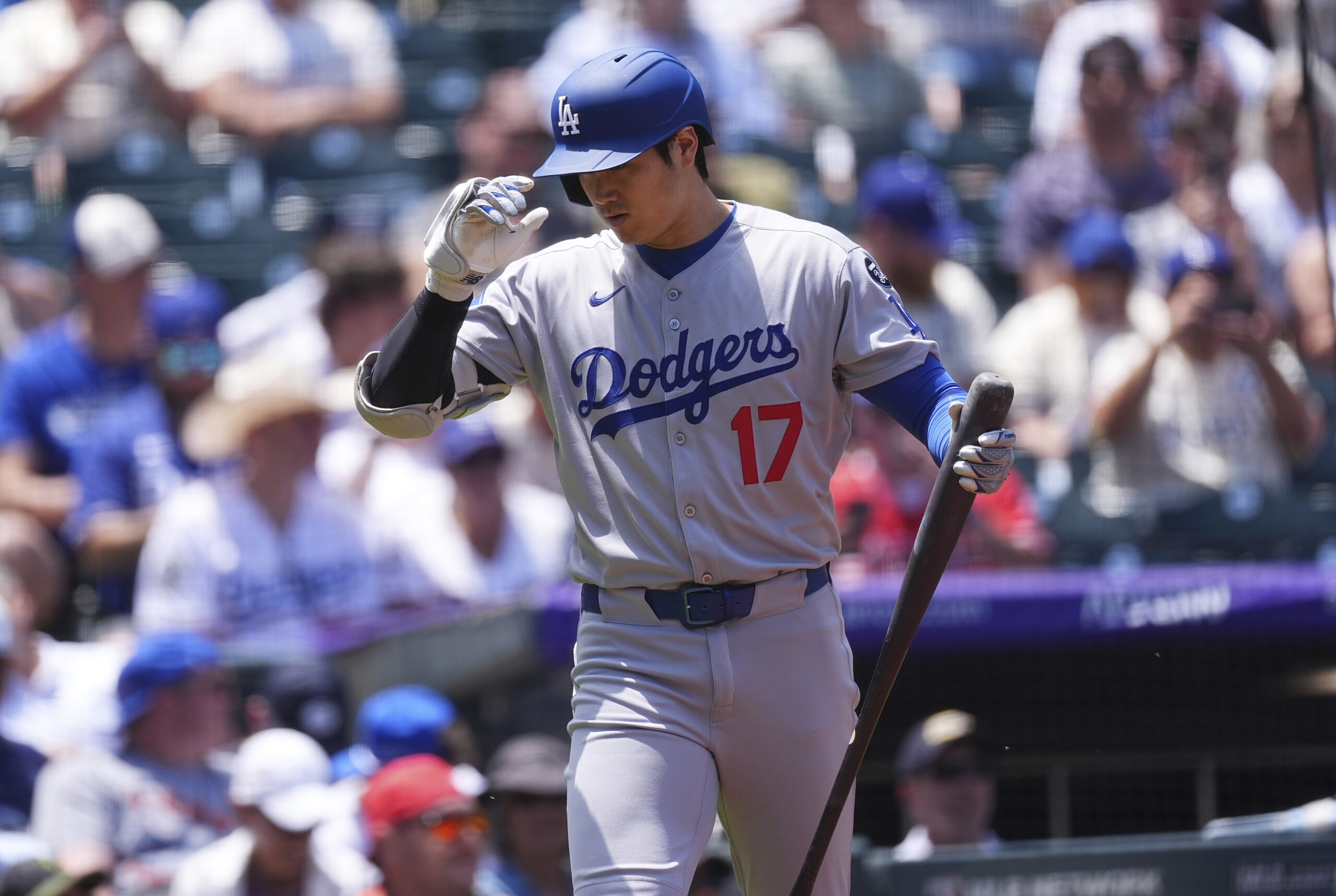 Dodgers star Shohei Ohtani doffs his batting helmet at the...