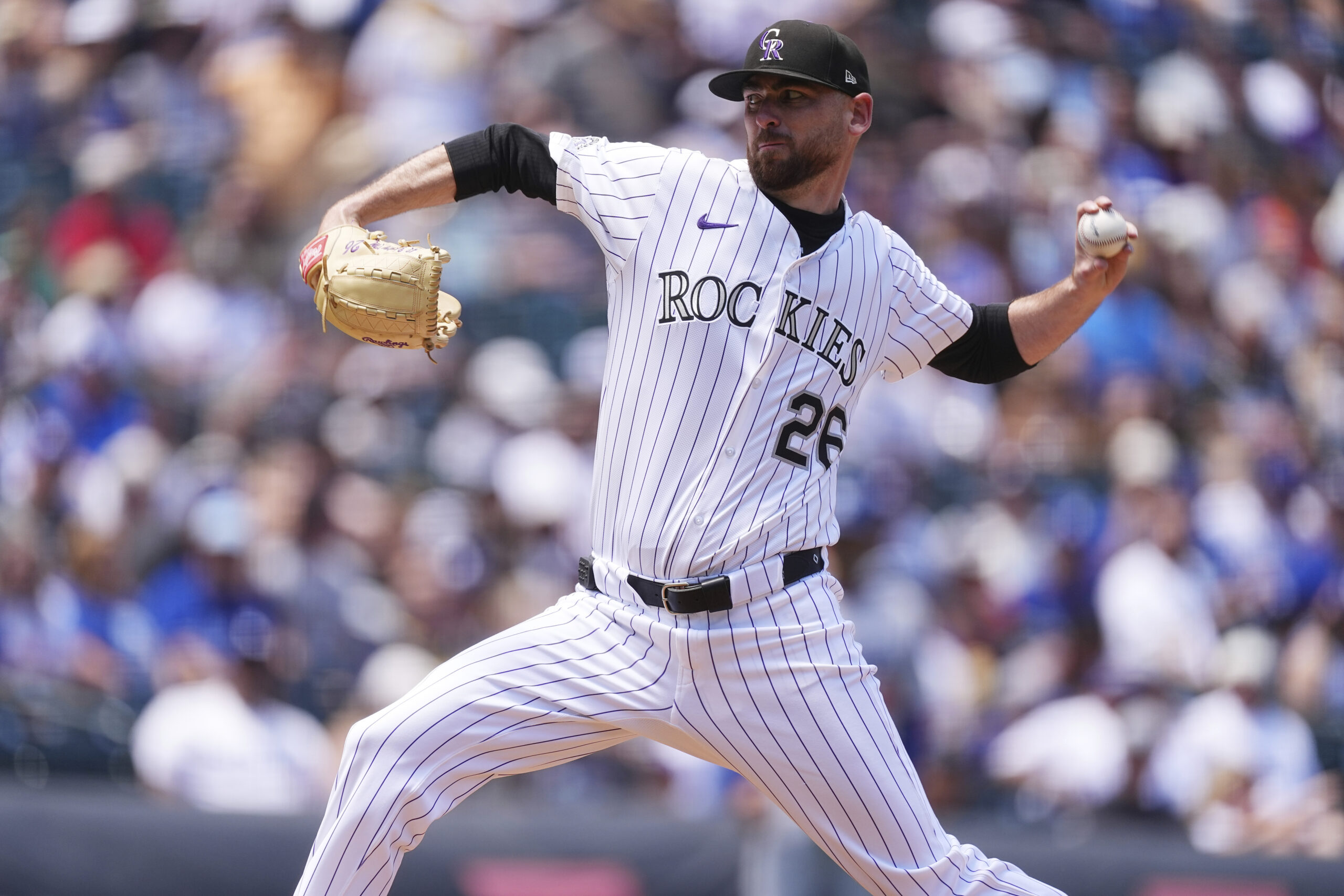 Colorado Rockies starting pitcher Austin Gomber throws to the plate...