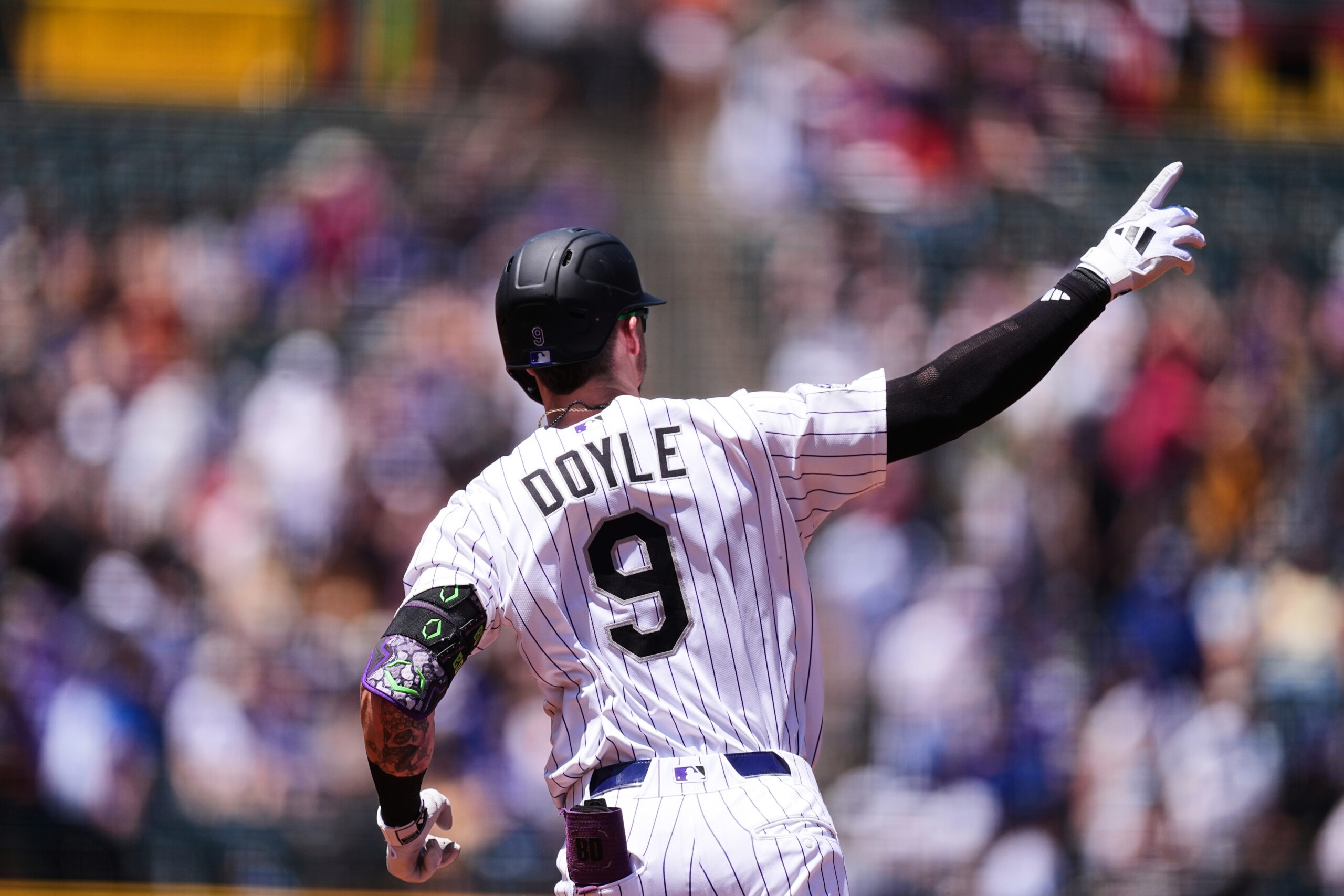The Colorado Rockies’ Brenton Doyle gestures as he runs the...