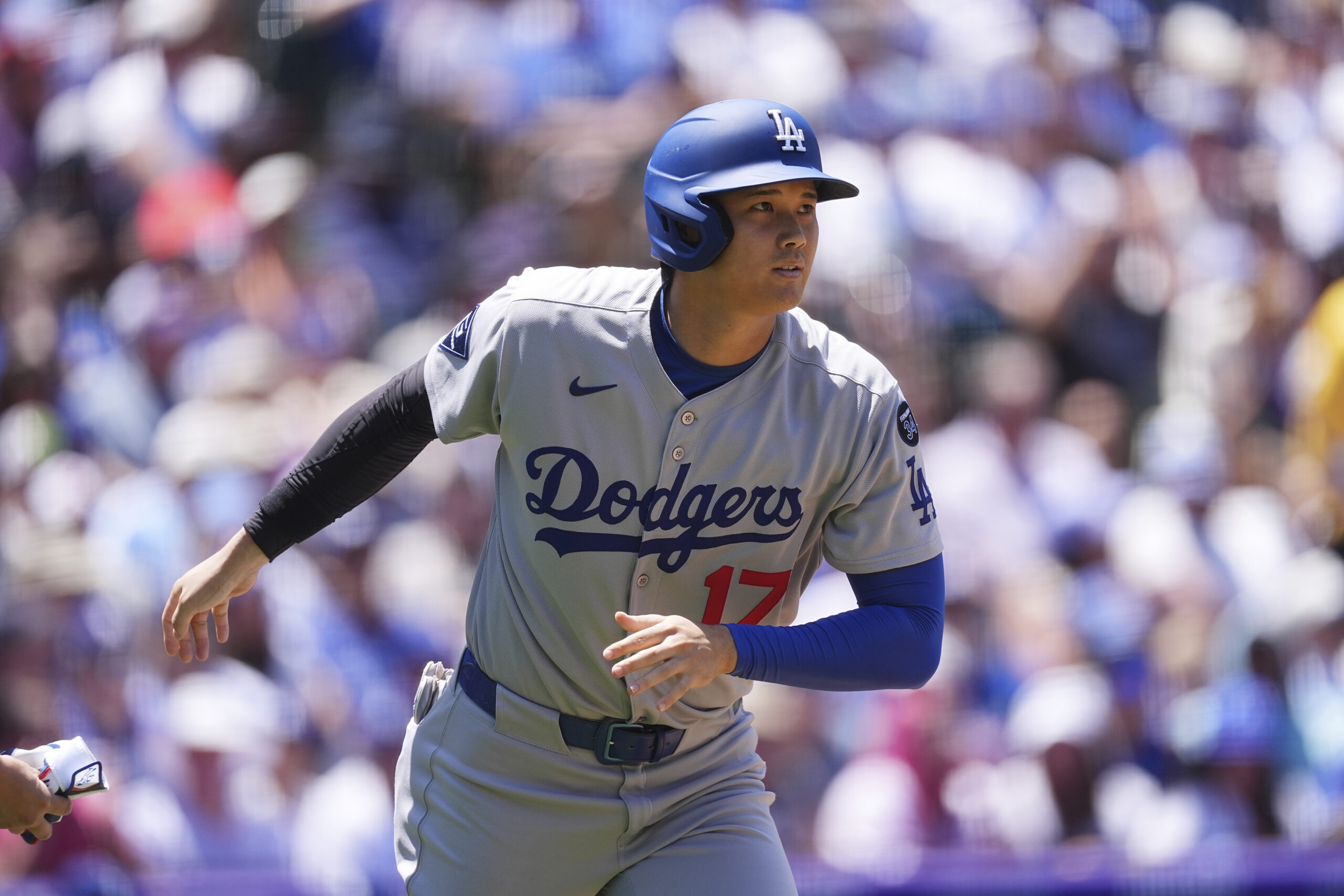 Dodgers star Shohei Ohtani heads up the first-base line after...