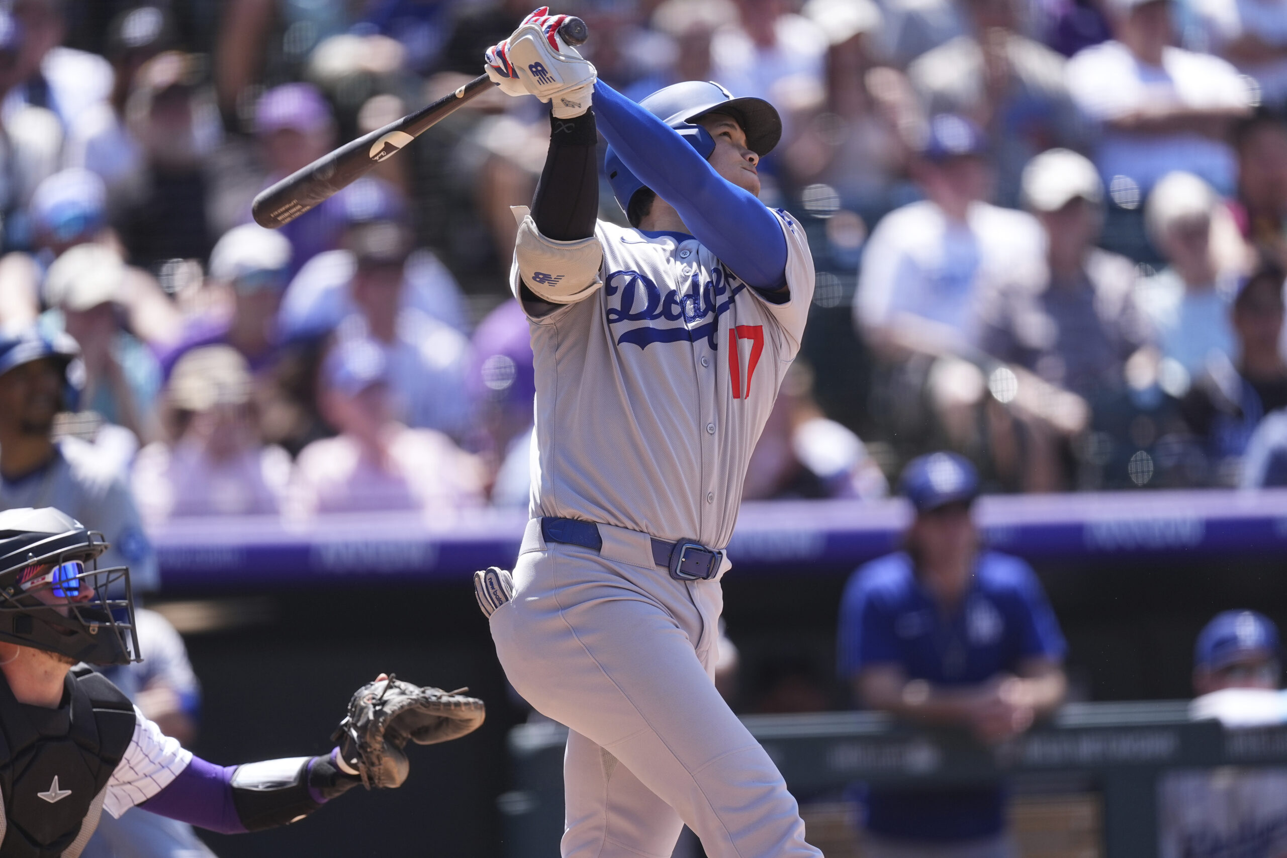Dodgers star Shohei Ohtani follows the flight of his solo...