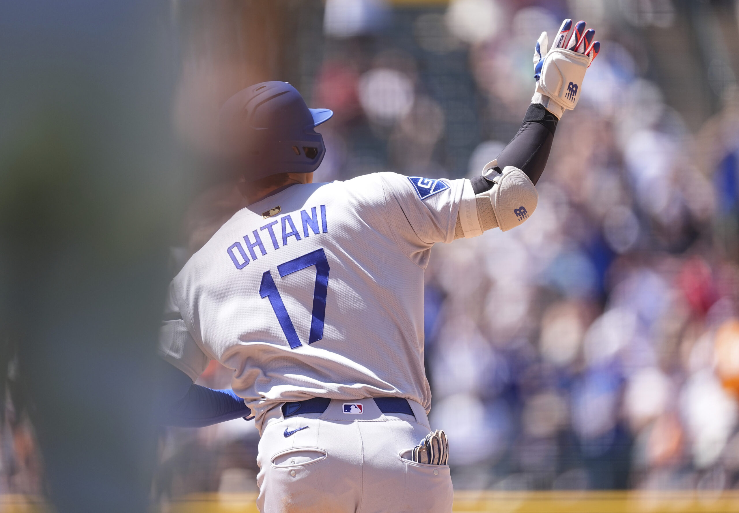 Dodgers star Shohei Ohtani gestures to the bullpen as he...