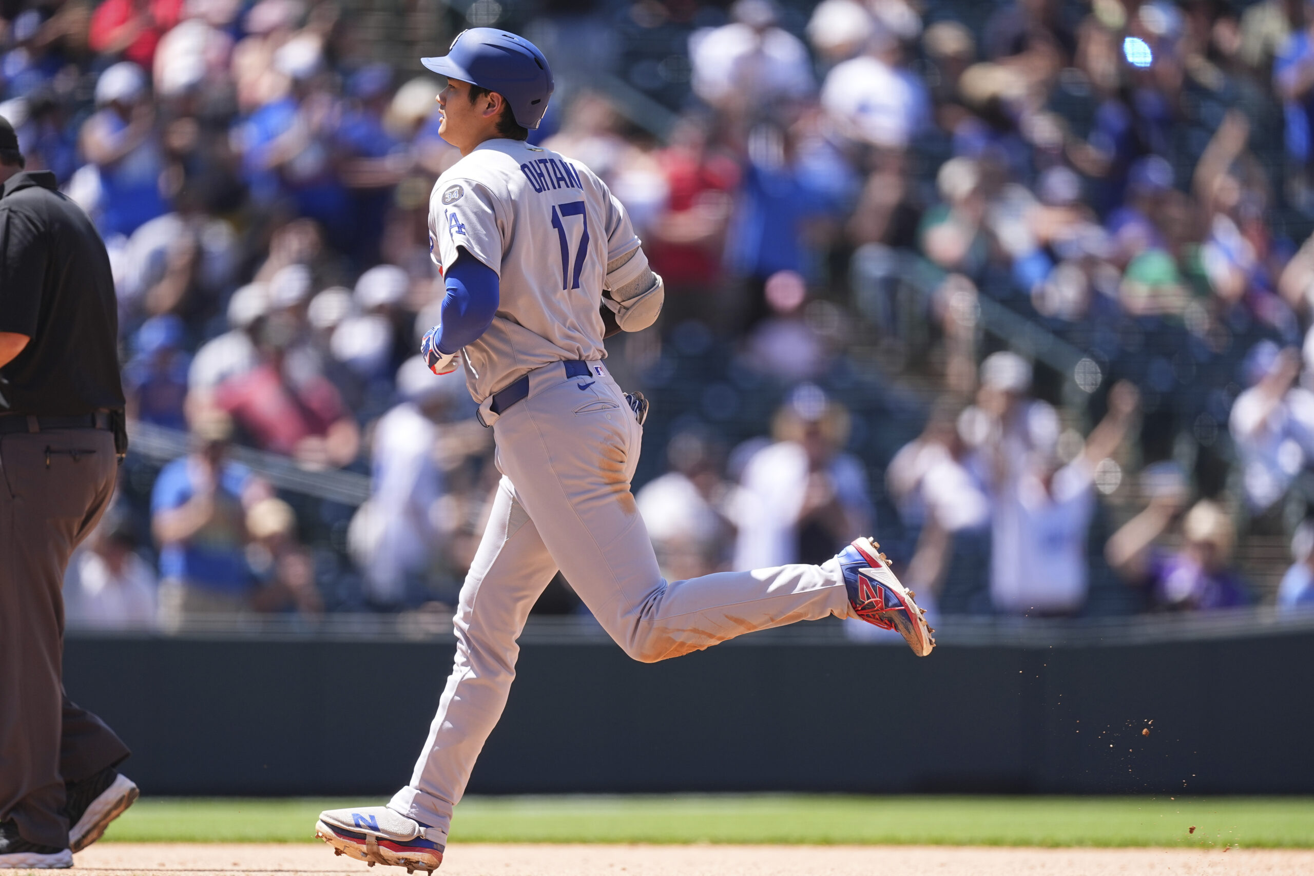 Dodgers star Shohei Ohtani circles the bases after hitting a...